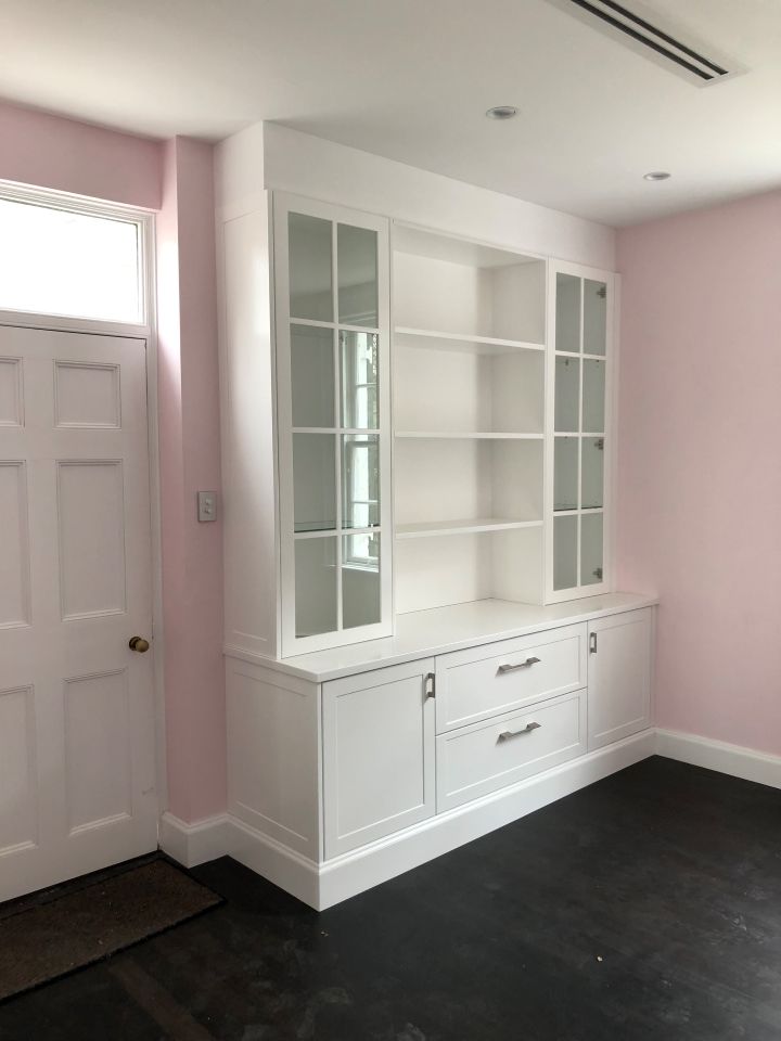 A Living Room With a Wine Rack and a Wicker Chair — High Kraft Kitchens and Joinery in Berkeley, NSW