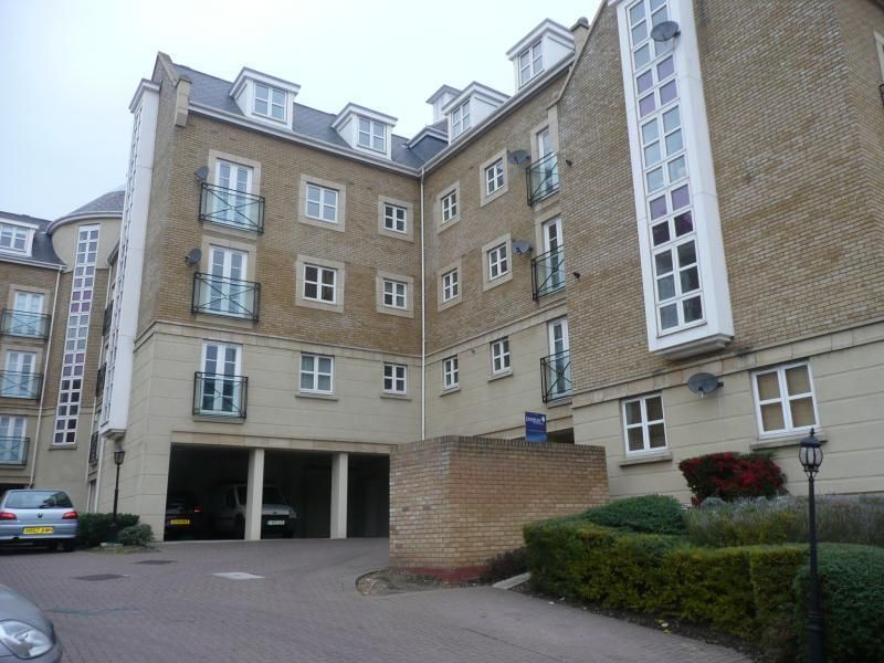 A large apartment building with a car parked in front of it