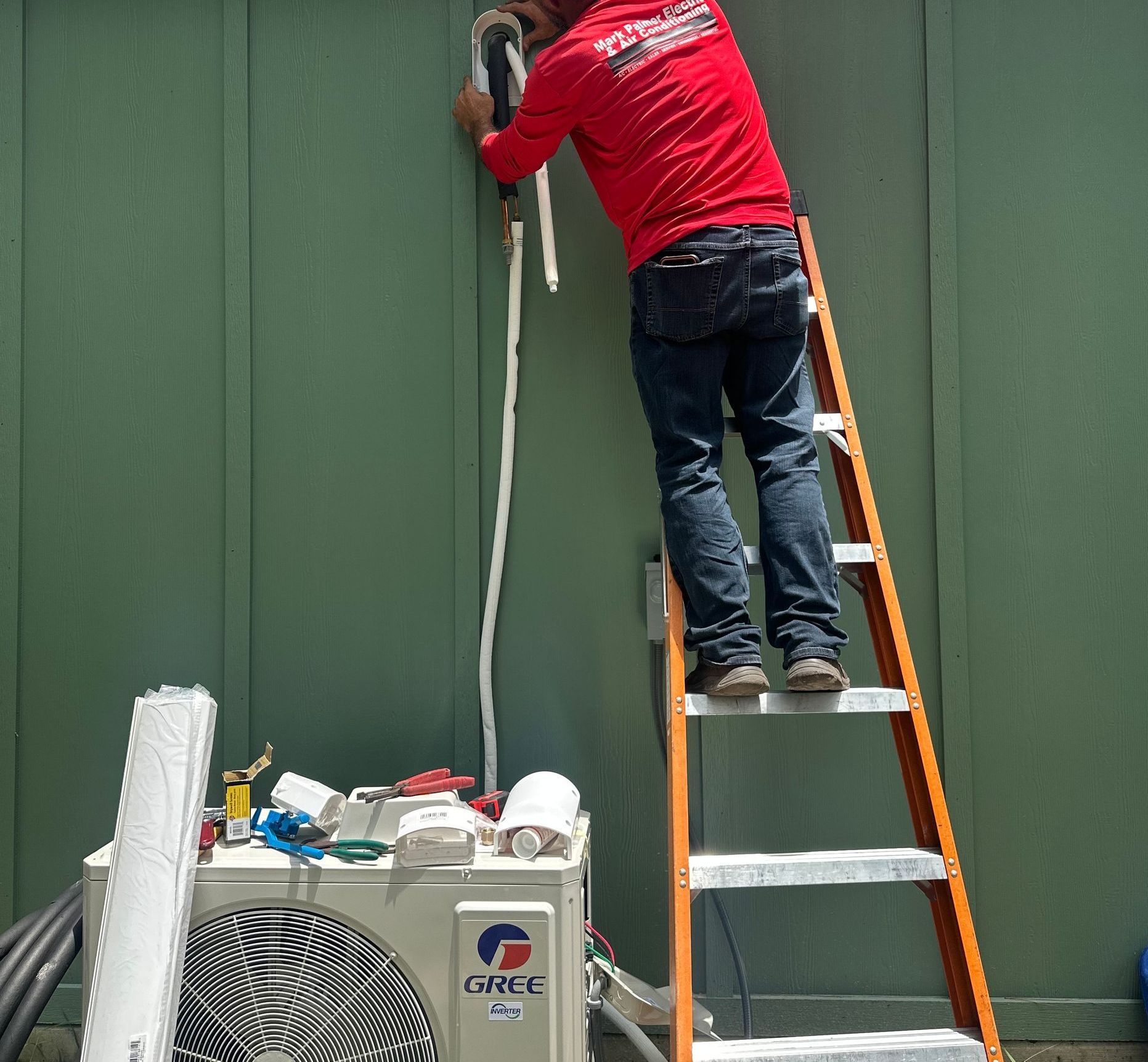 Mark Palmer worker inspecting outdoor a/c unit for customer
