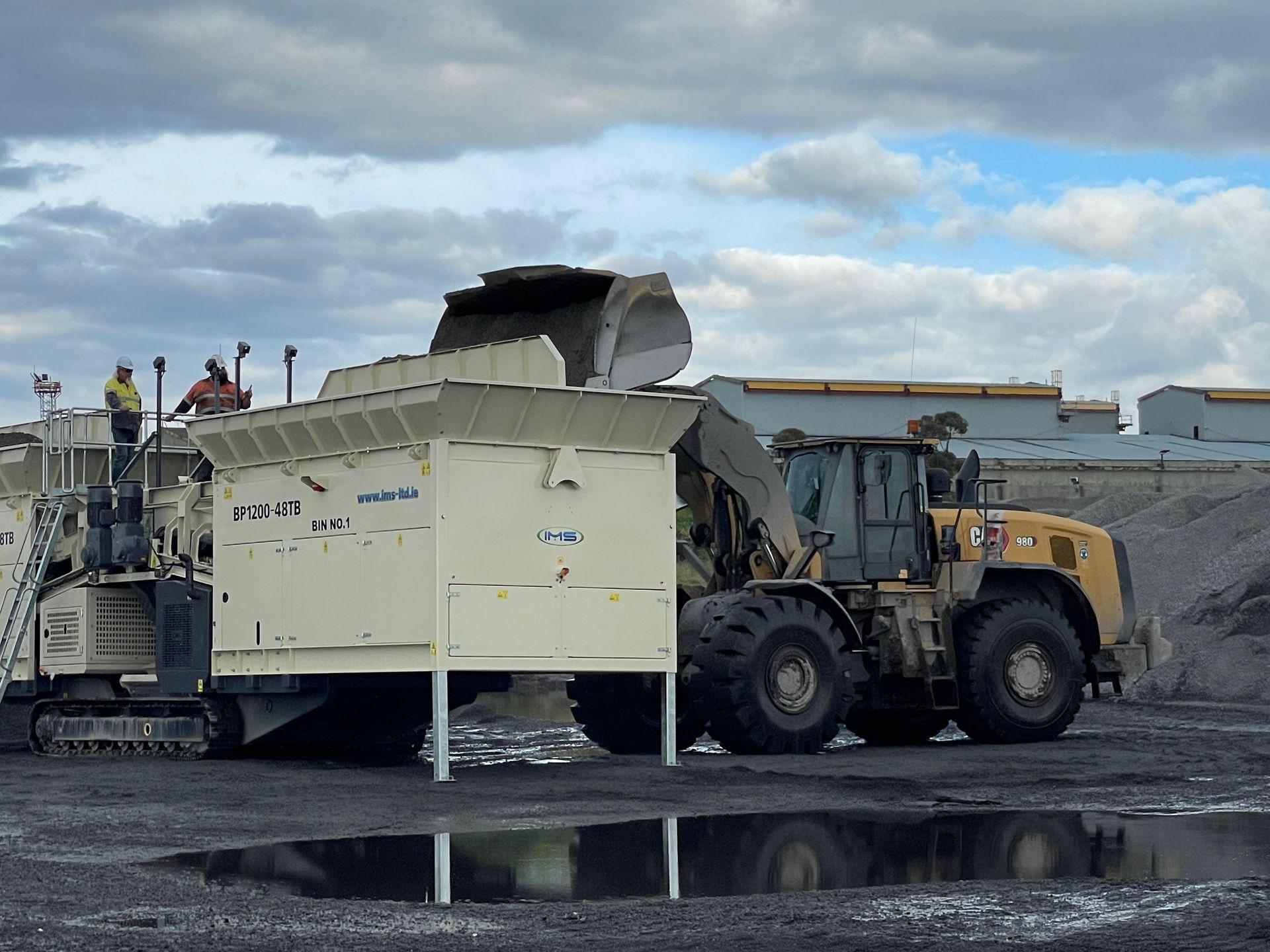 A large tractor is parked next to a smaller tractor