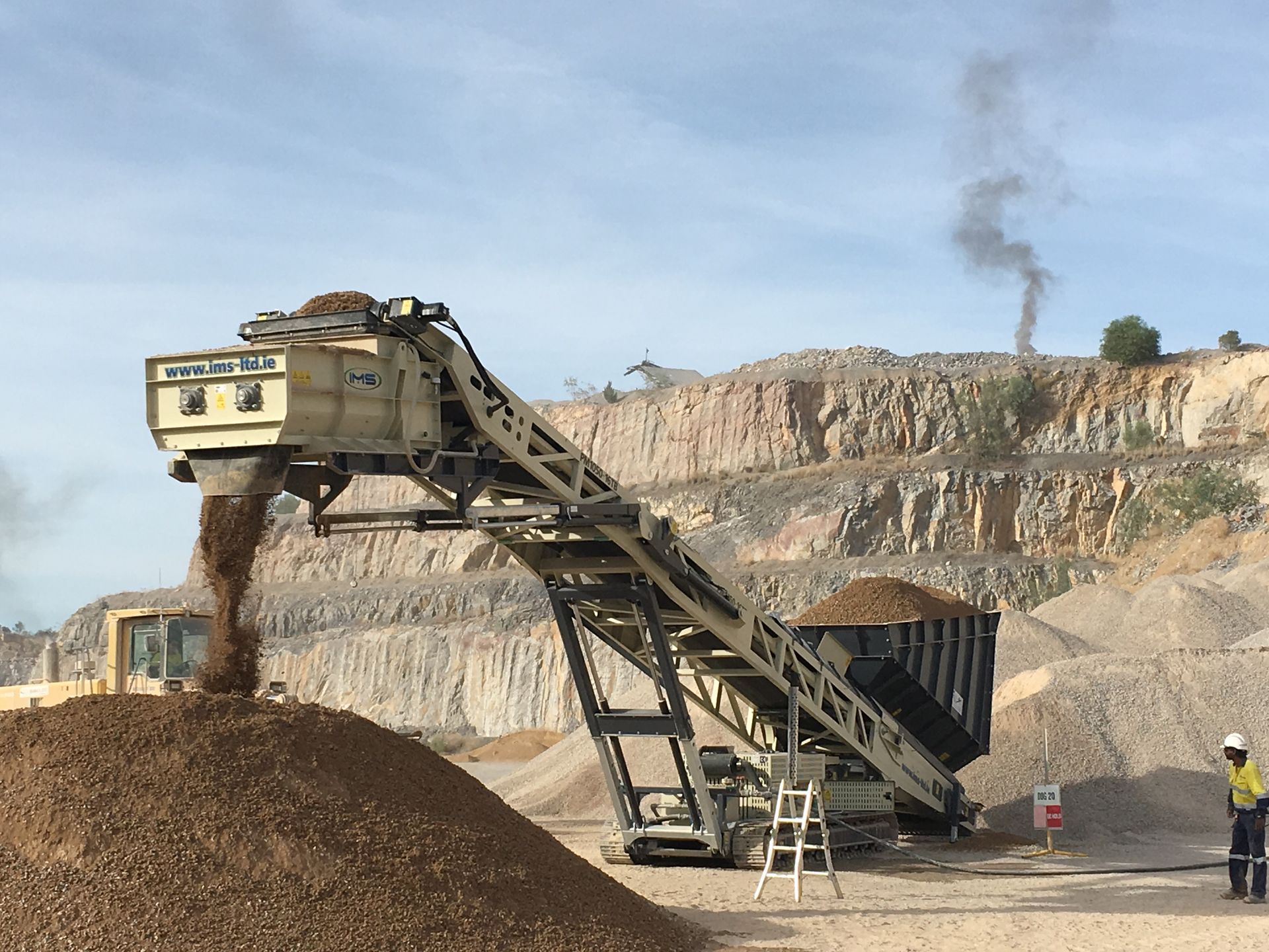 A Large Pile Of Dirt Is Being Loaded Onto A Conveyor  Bellt — Yatala Qld — Crusher Screen Sales & Hire