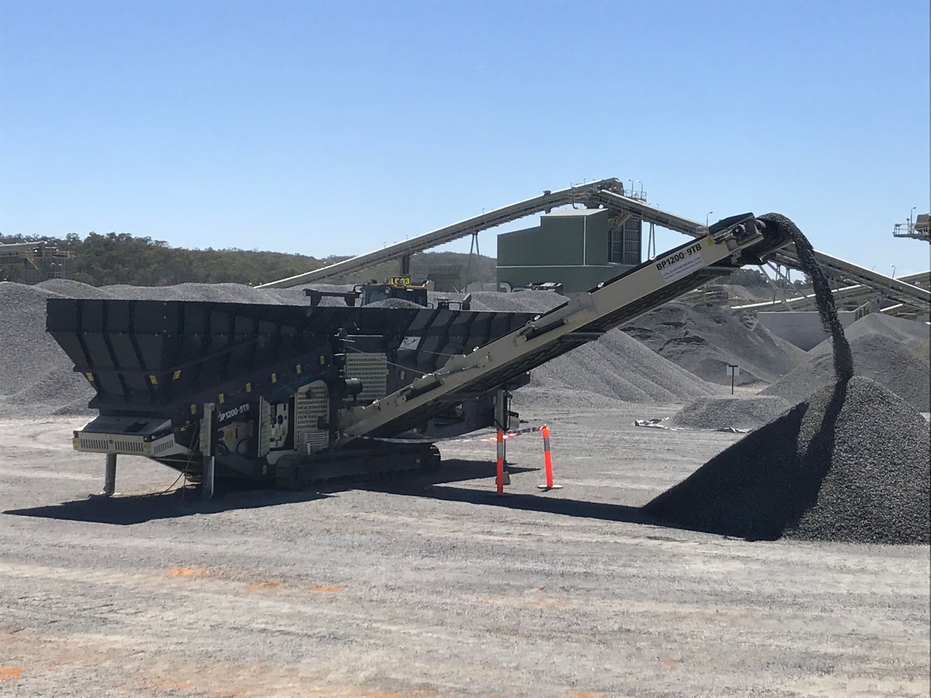 A Conveyor Belt Is Carrying A Large Pile Of Coal — Yatala Qld — Crusher Screen Sales & Hire