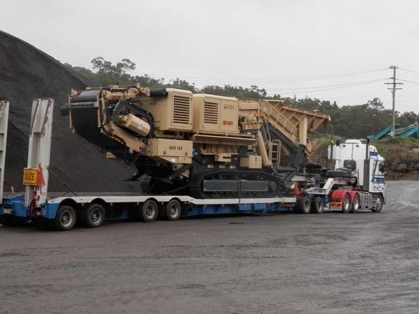 beige crusher on trailer