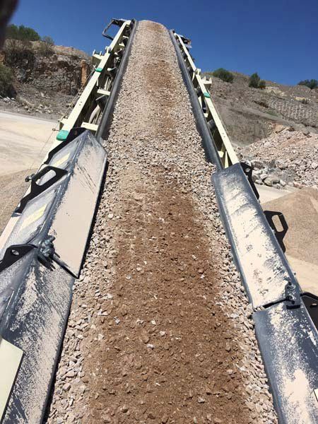 track pugmill conveyor with materials in it