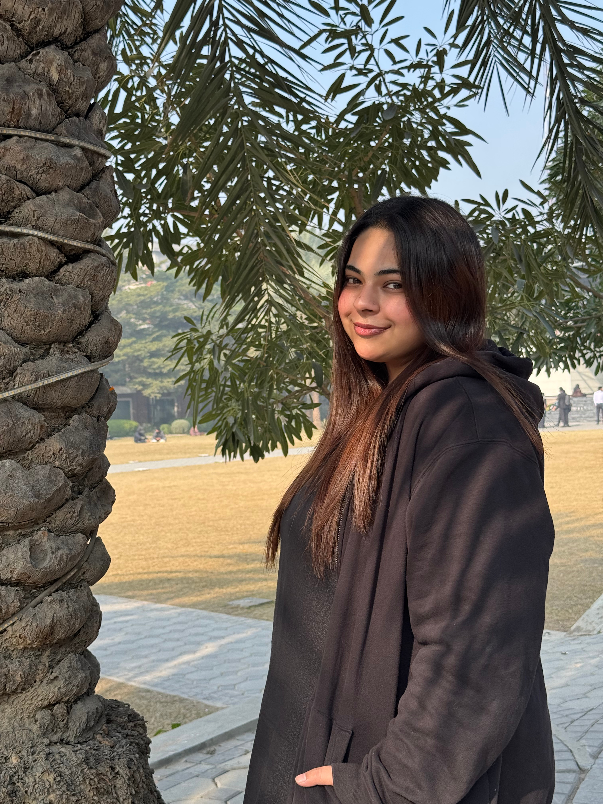 jannat kamran headshot, field background, tree, standing portrait