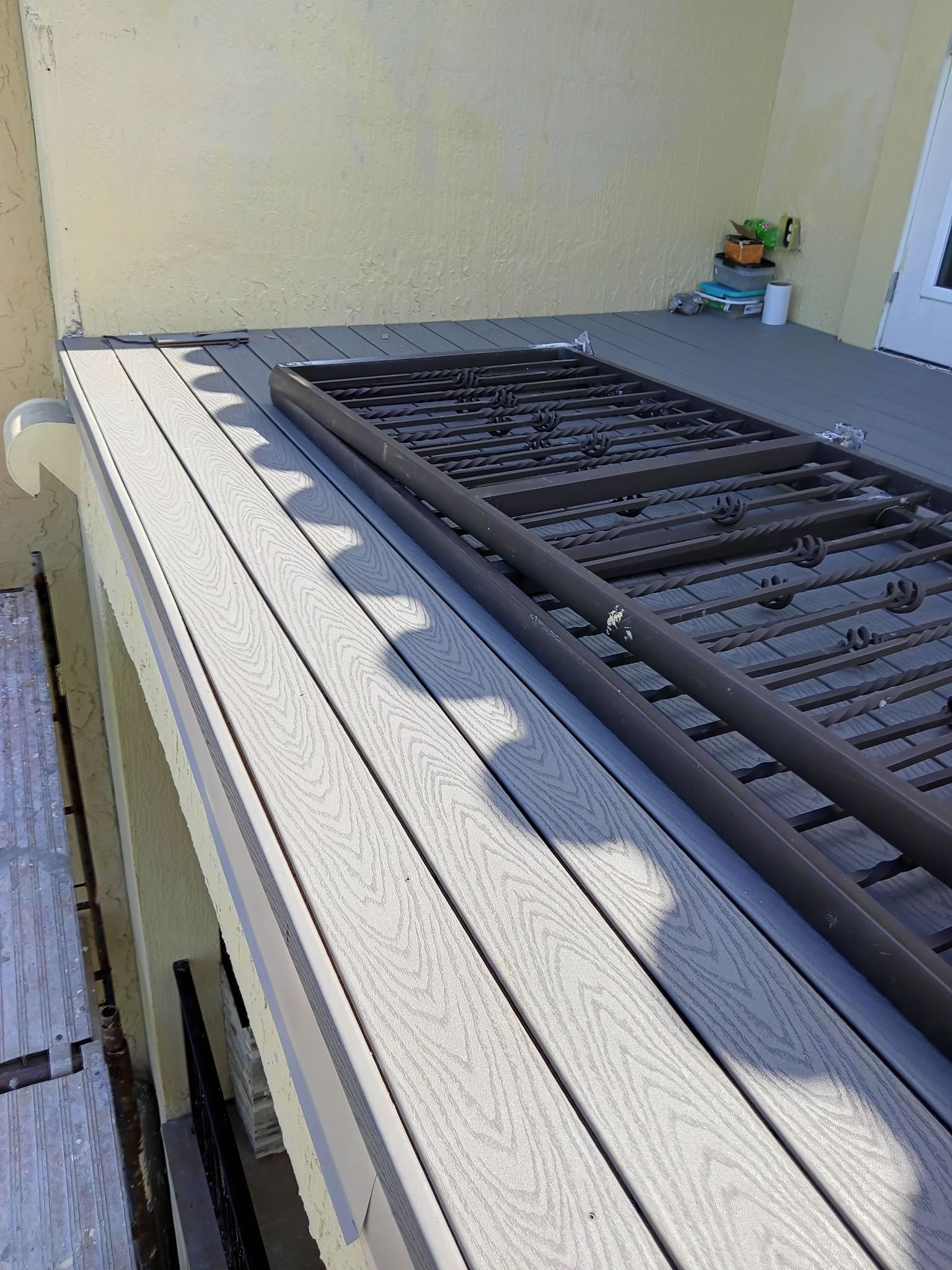 Composite deck with a disassembled dark metal frame.