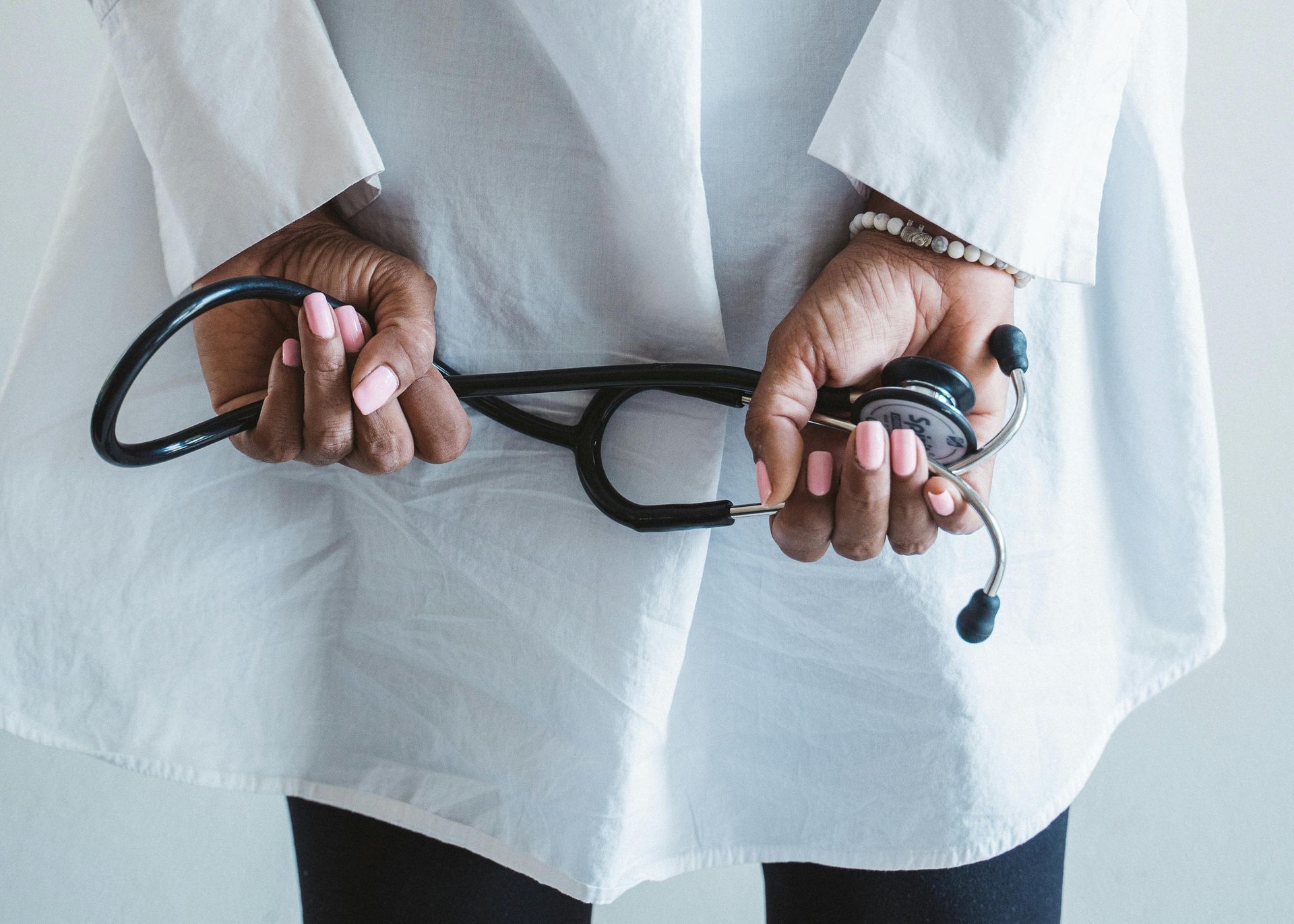 A doctor's hands holding a stethoscope