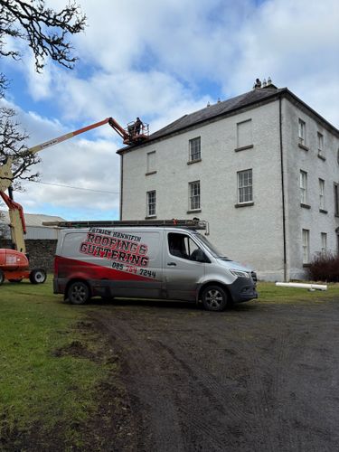 A van is parked on the side of the road in front of a building.