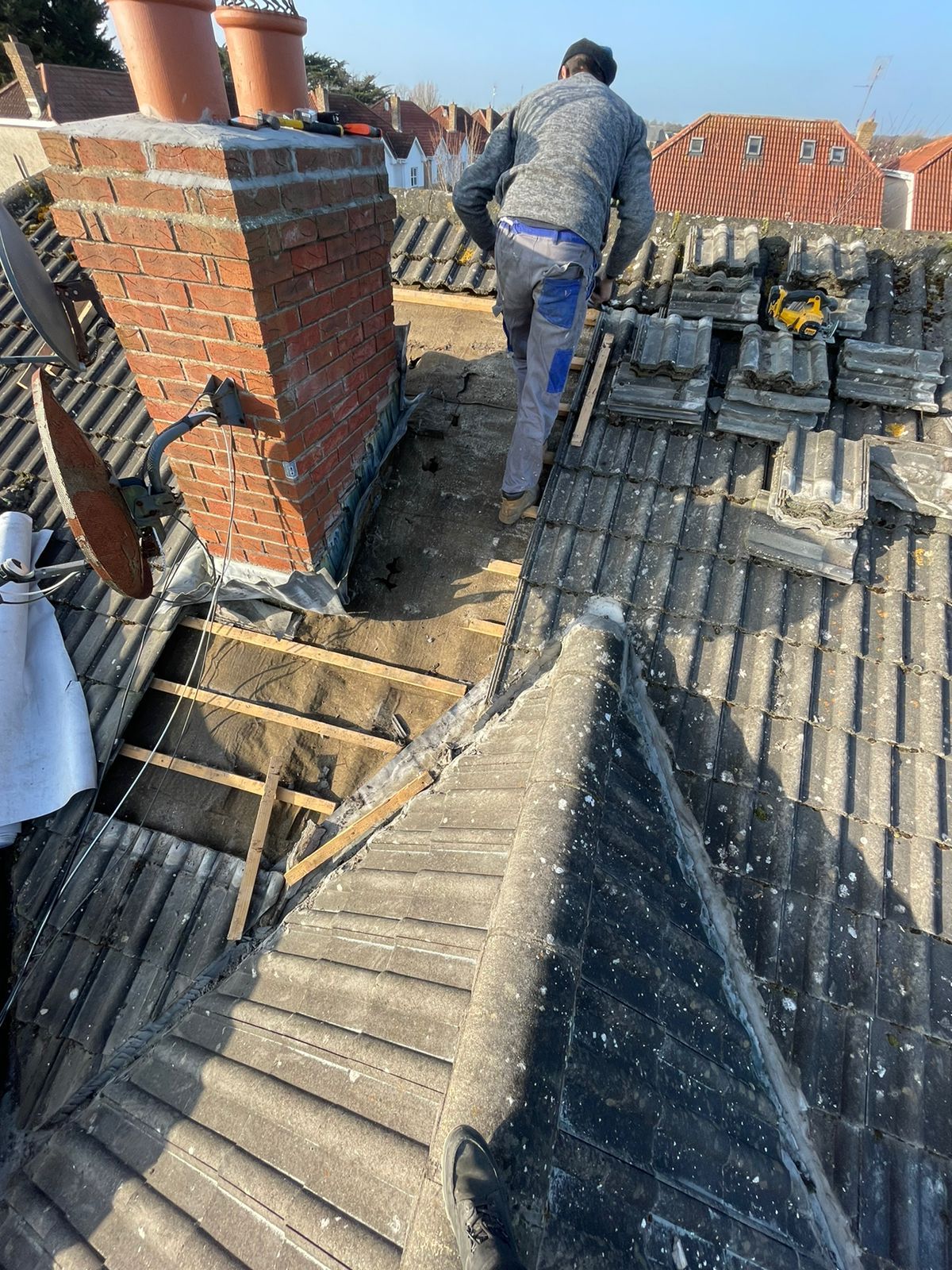 A man is working on the roof of a building.