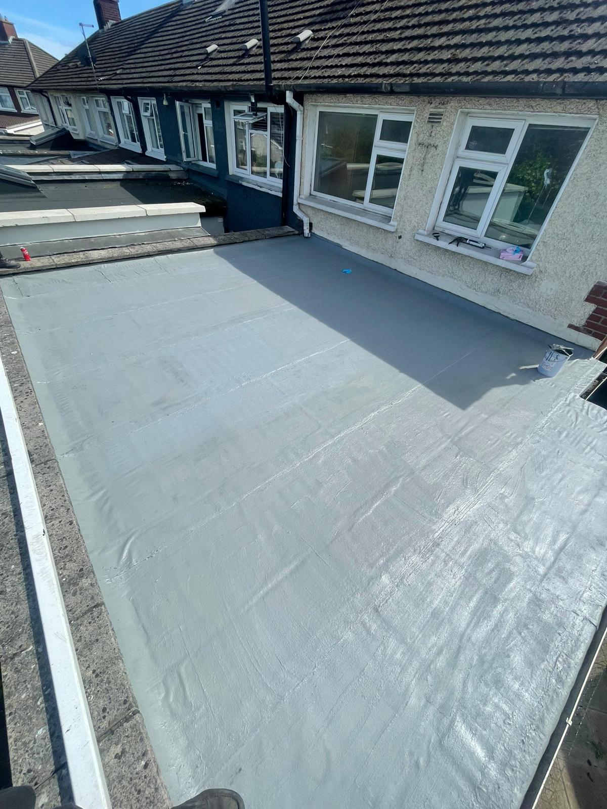 A roof with a roofing material on it is being installed on a house.