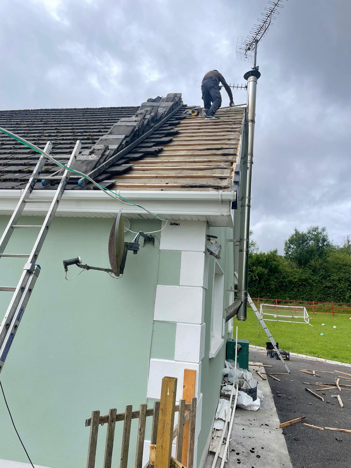 A man is working on the roof of a house.