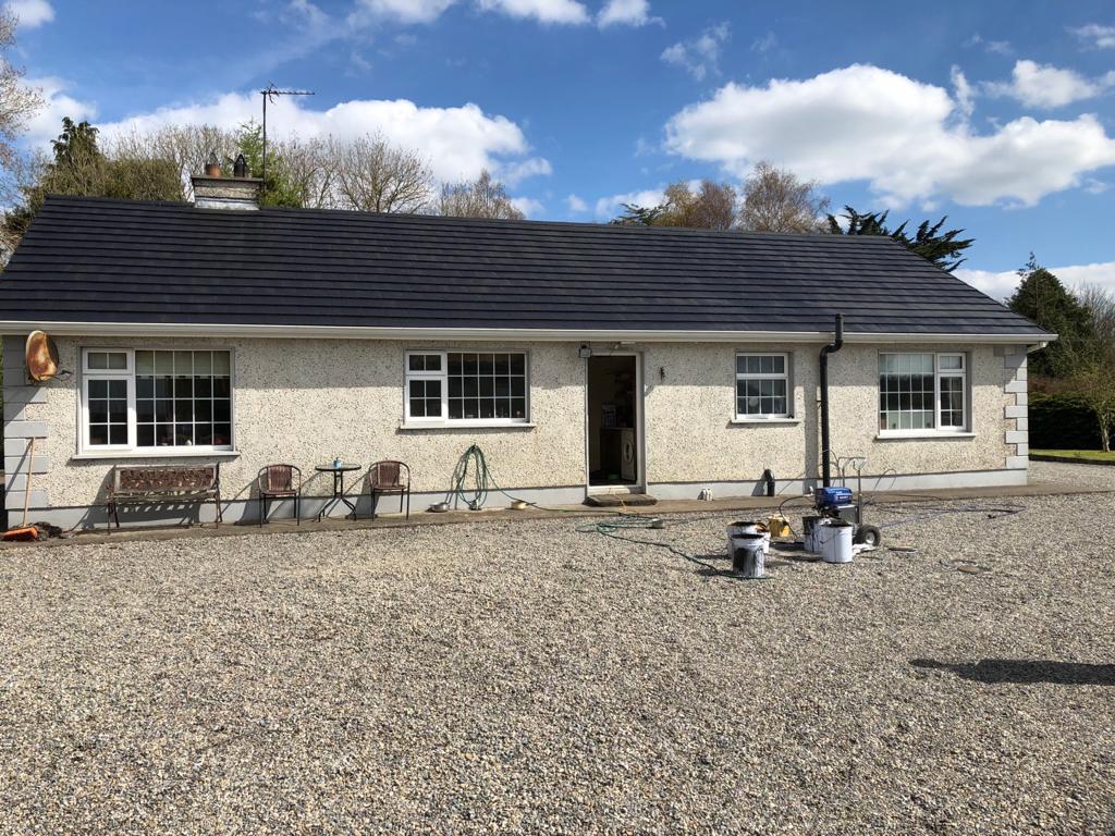A house with a gravel driveway in front of it