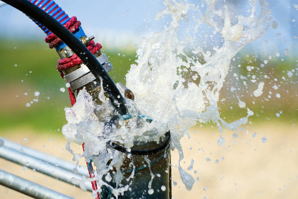 a close up of water splashing out of a pipe