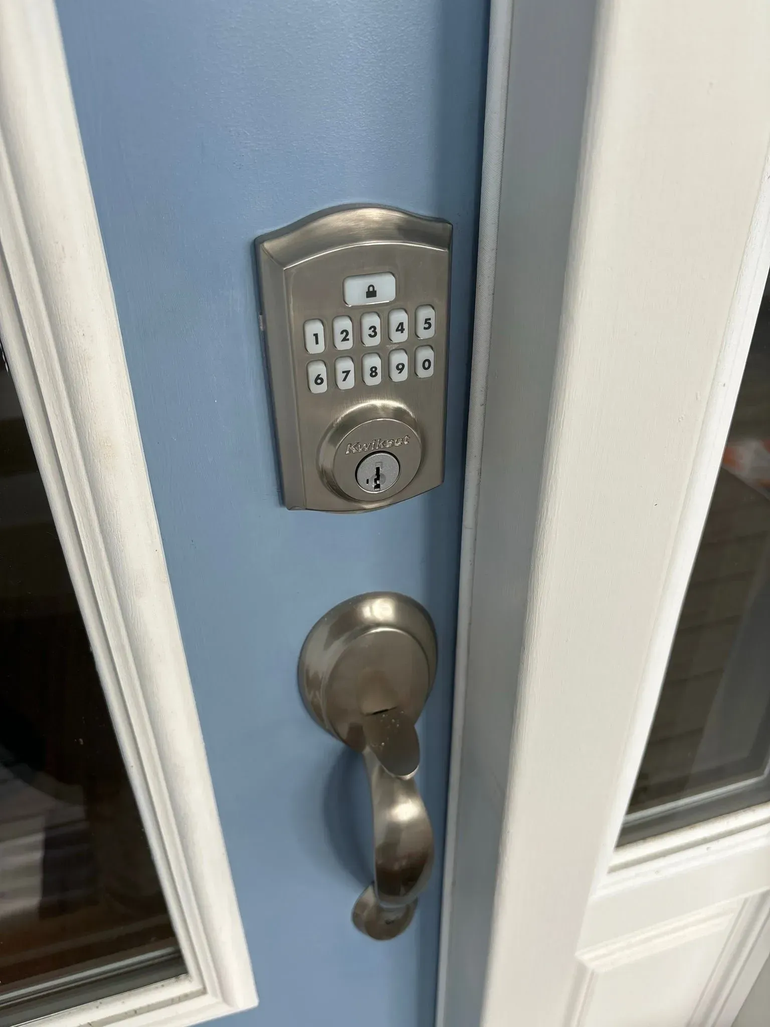 A close up of a door with a keypad on it.