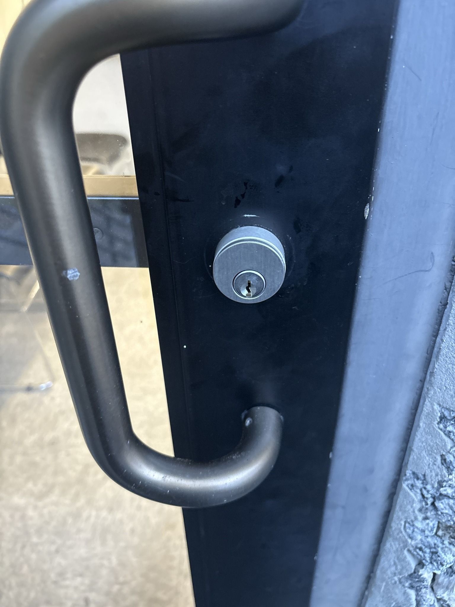 A close up of a door with a handle and a lock.