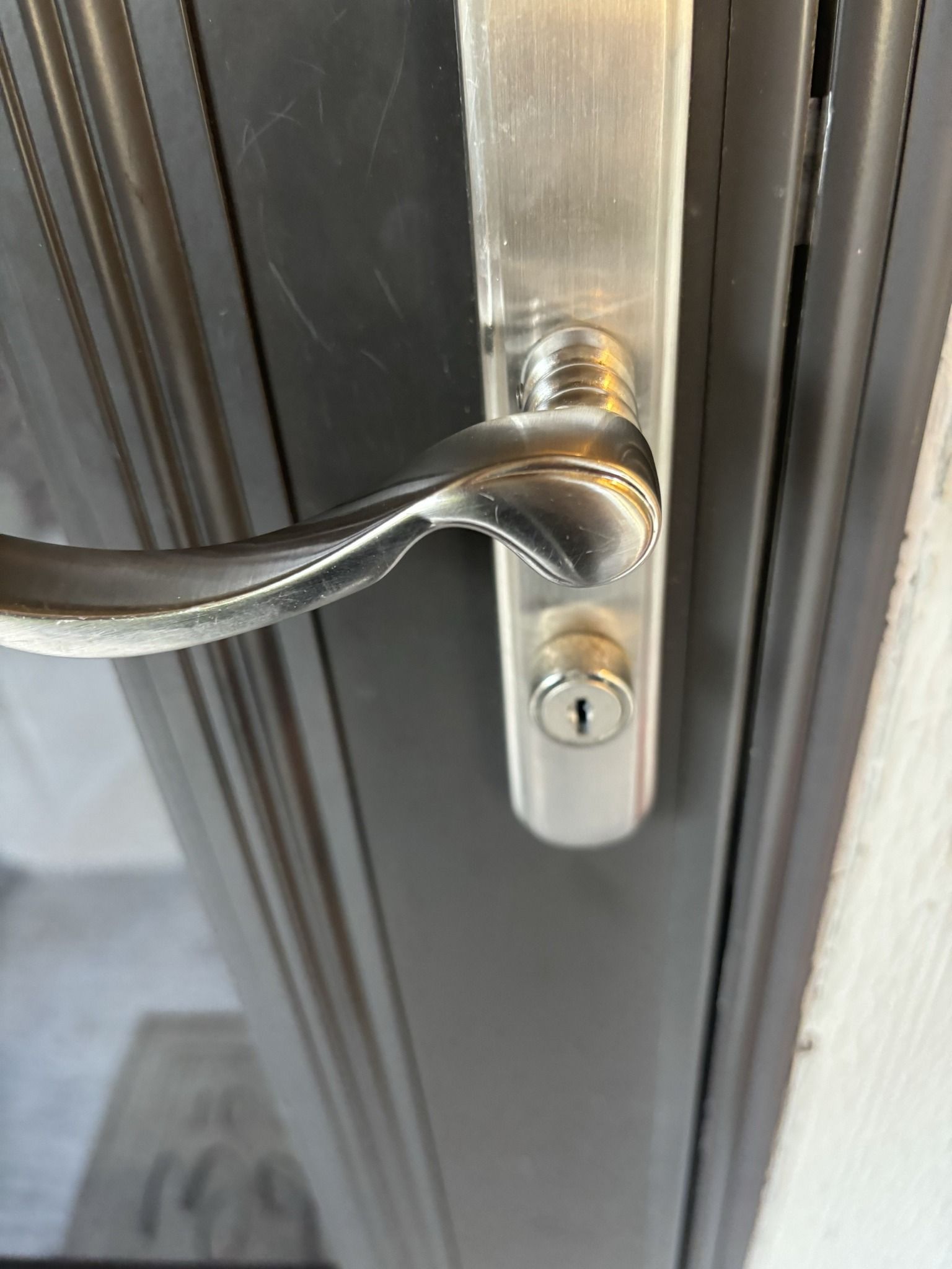 A close up of a door handle with a key on it.