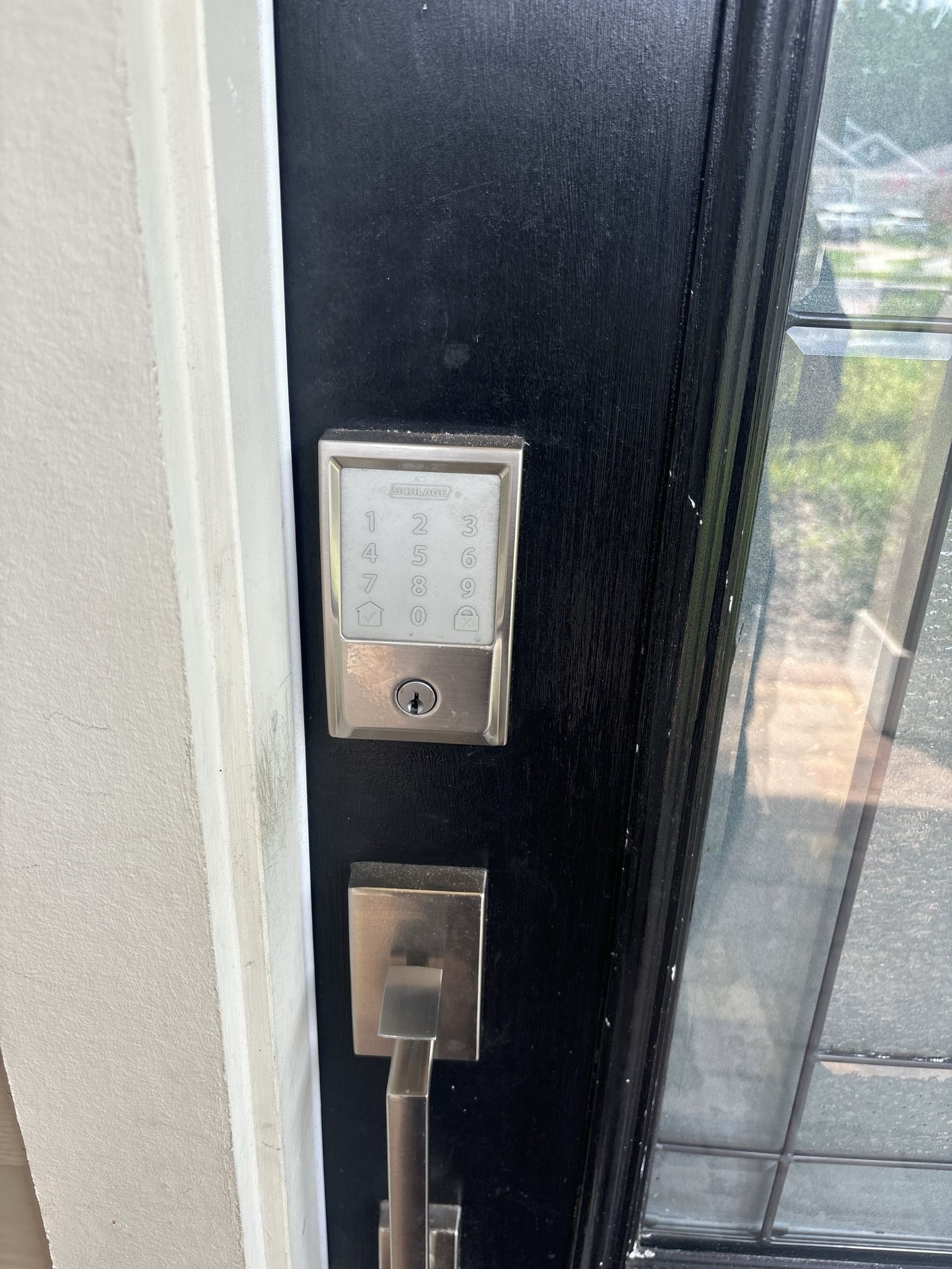 A close up of a door with a keypad on it.