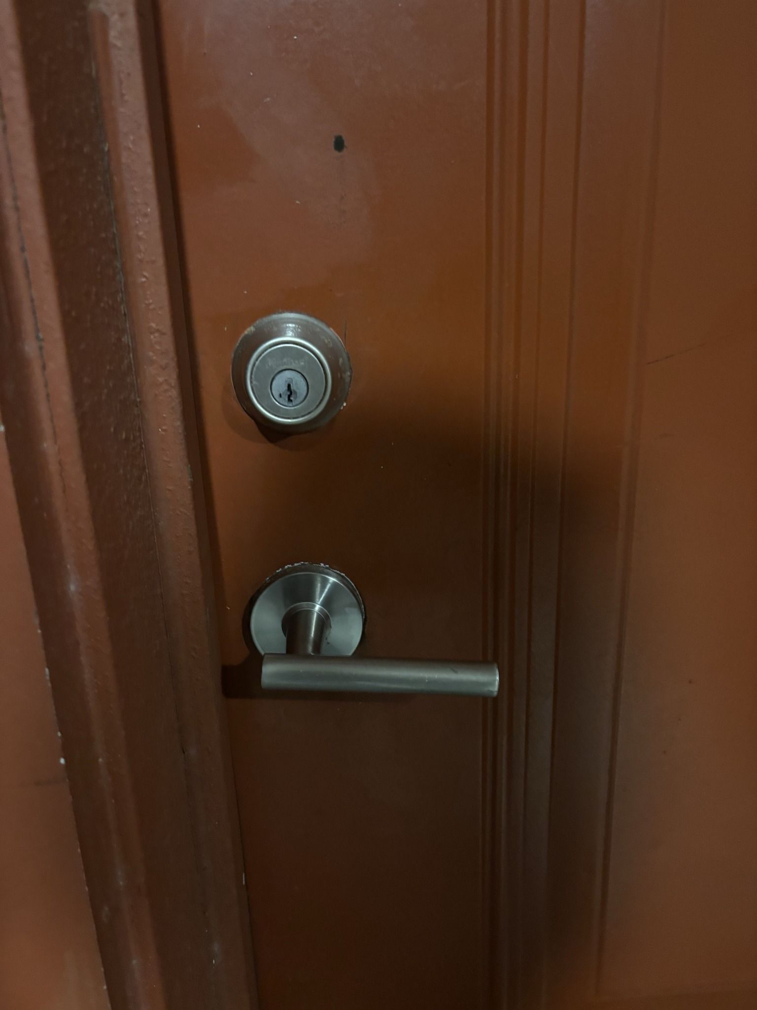 A close up of a door with a handle and lock.