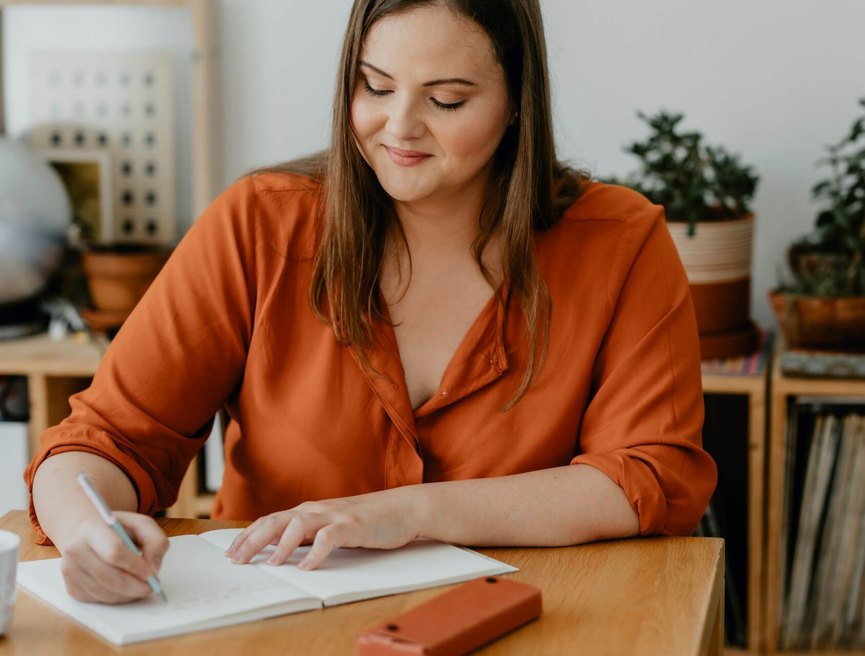 Woman writes her thoughts down.