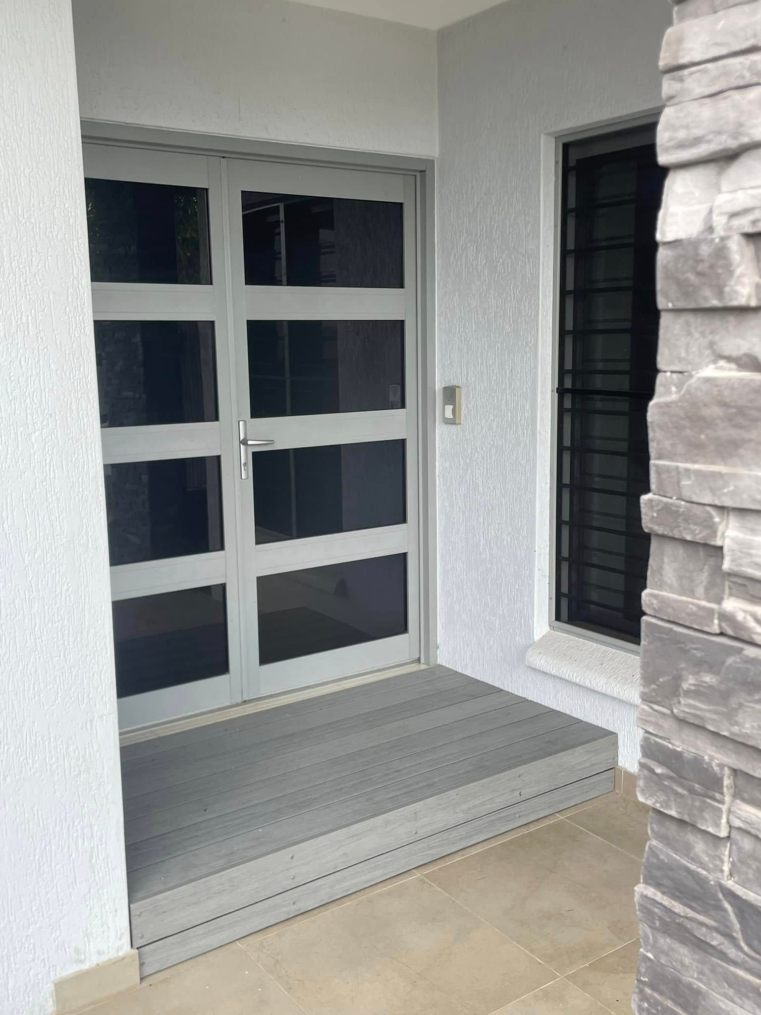 Gray Entryway With a Glass-paned Door and a Small Step Leading to It — Northco Constructions In Muirhead, NT