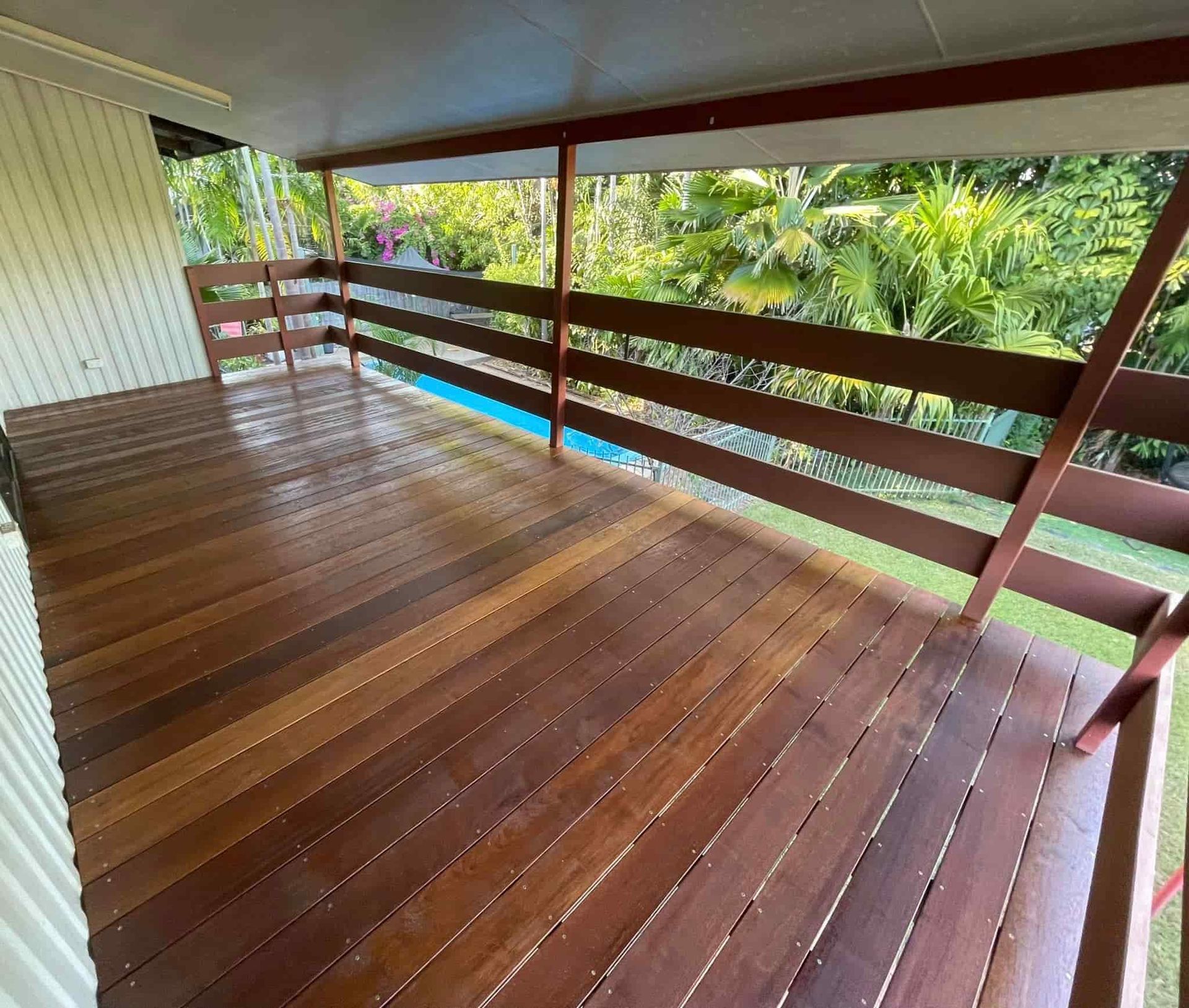 Wooden Deck With Brown Railings and a View of Lush Green Foliage — Northco Constructions In Muirhead, NT