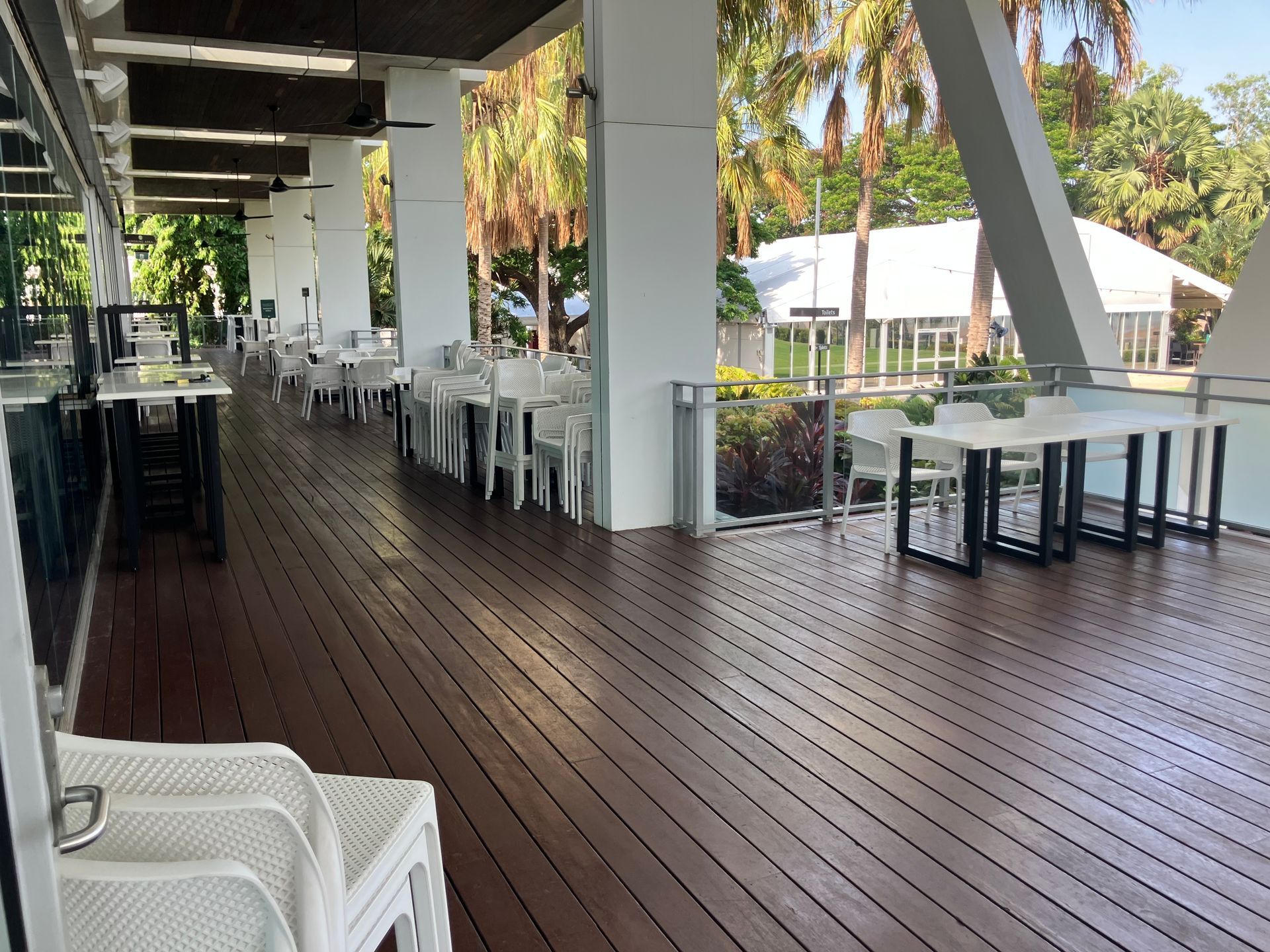 A Man in Work Clothes, Working on A Metal Gutter with Pliers, Outdoors — Northco Constructions In Muirhead, NT