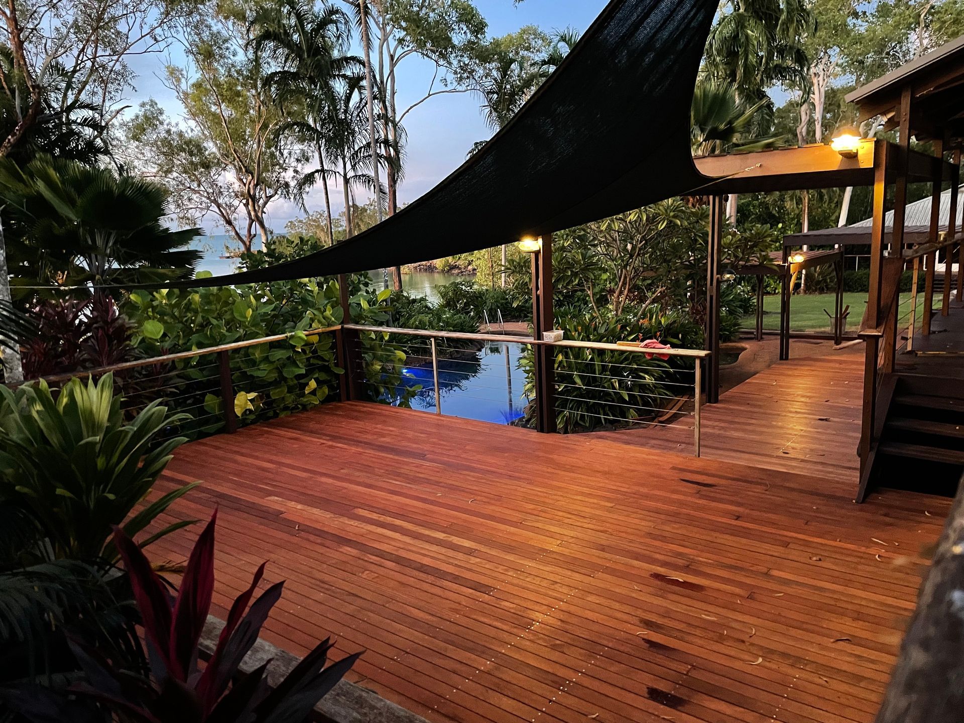 Wooden Deck With Pool, Shade Sail, and Lush Greenery — Northco Constructions In Muirhead, NT