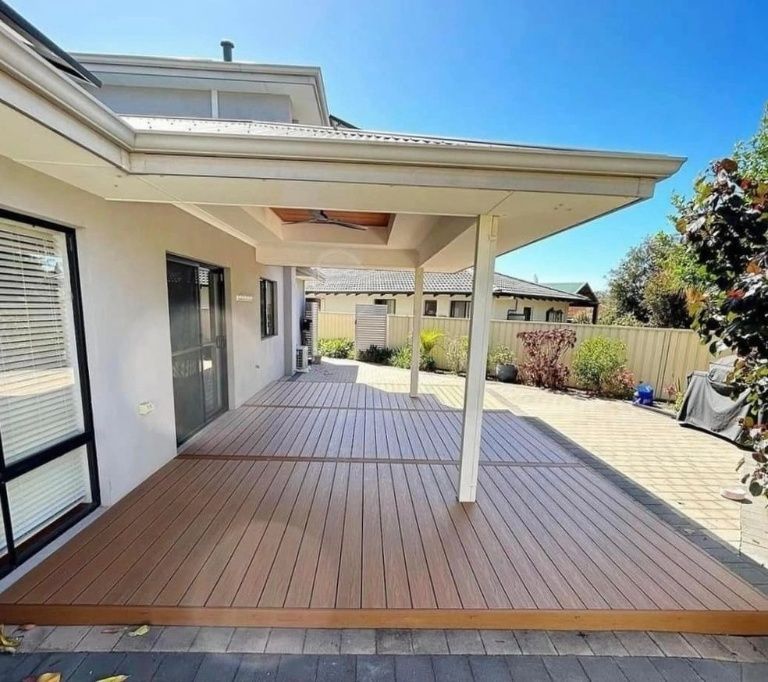 A Spacious Wooden Deck Extends From a Light-colored House Under a Covered Patio — Northco Constructions In Muirhead, NT