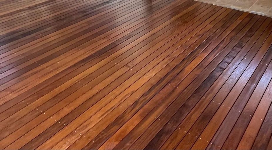 Wooden Floor With Parallel Dark Brown Planks, Reflecting Light — Northco Constructions In Muirhead, NT