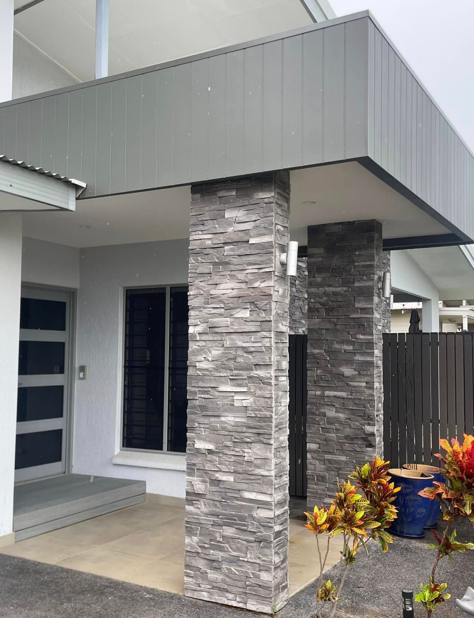 Person in Plaid Shirt Marks Wood with A Pencil and Ruler on A Workbench. Tools and Paper Are Nearby — Northco Constructions In Muirhead, NT