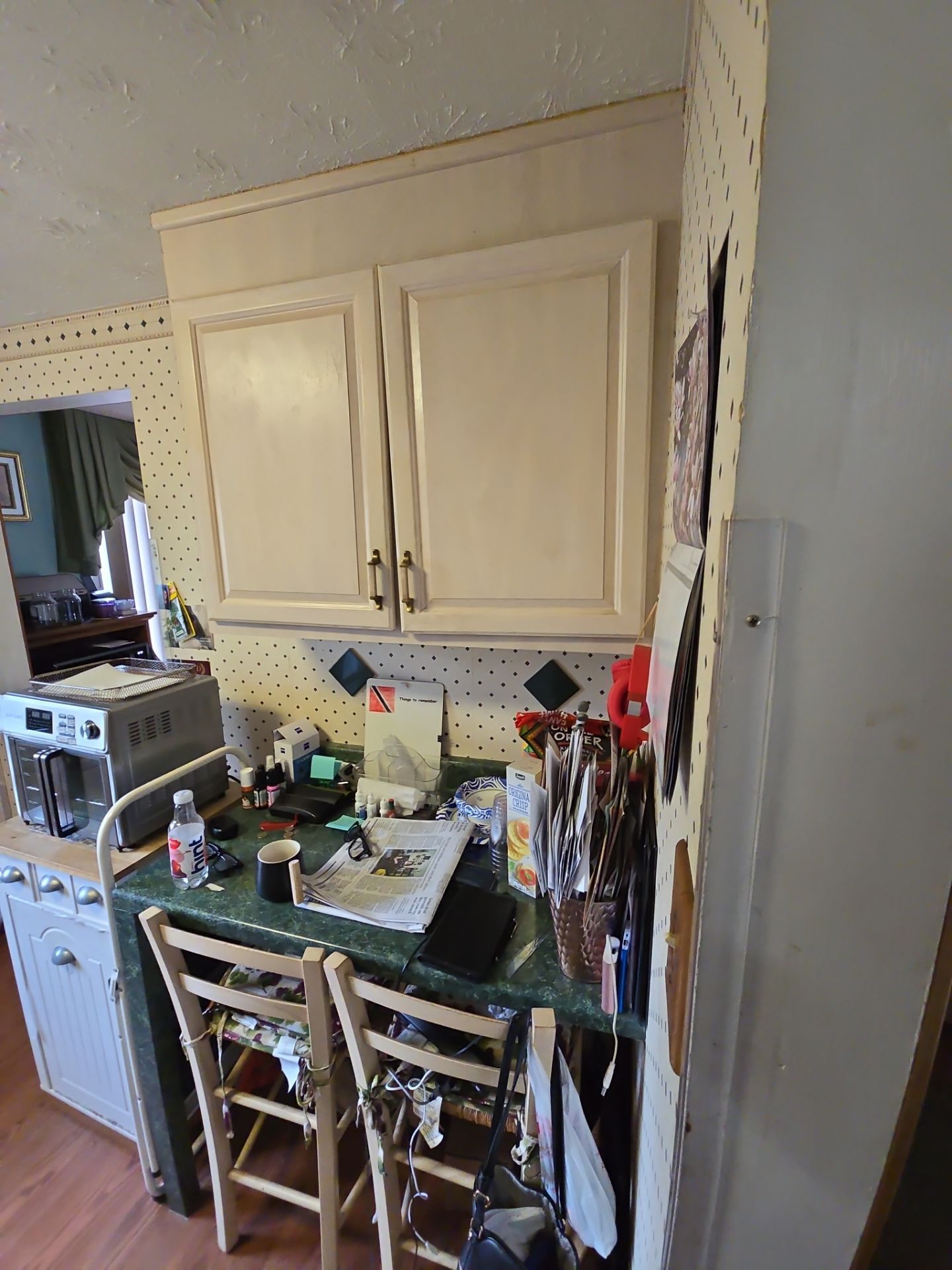 A kitchen with a table and chairs and a microwave.