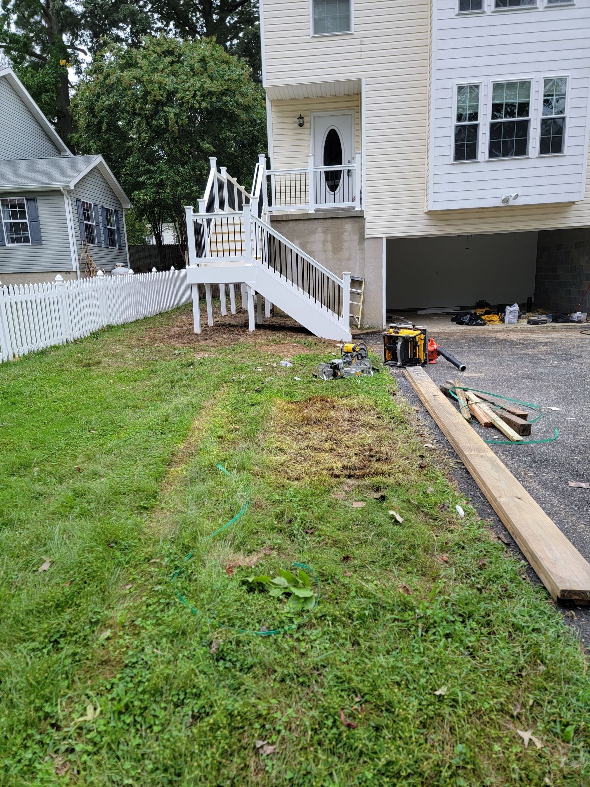 A house with a deck and stairs in the backyard.