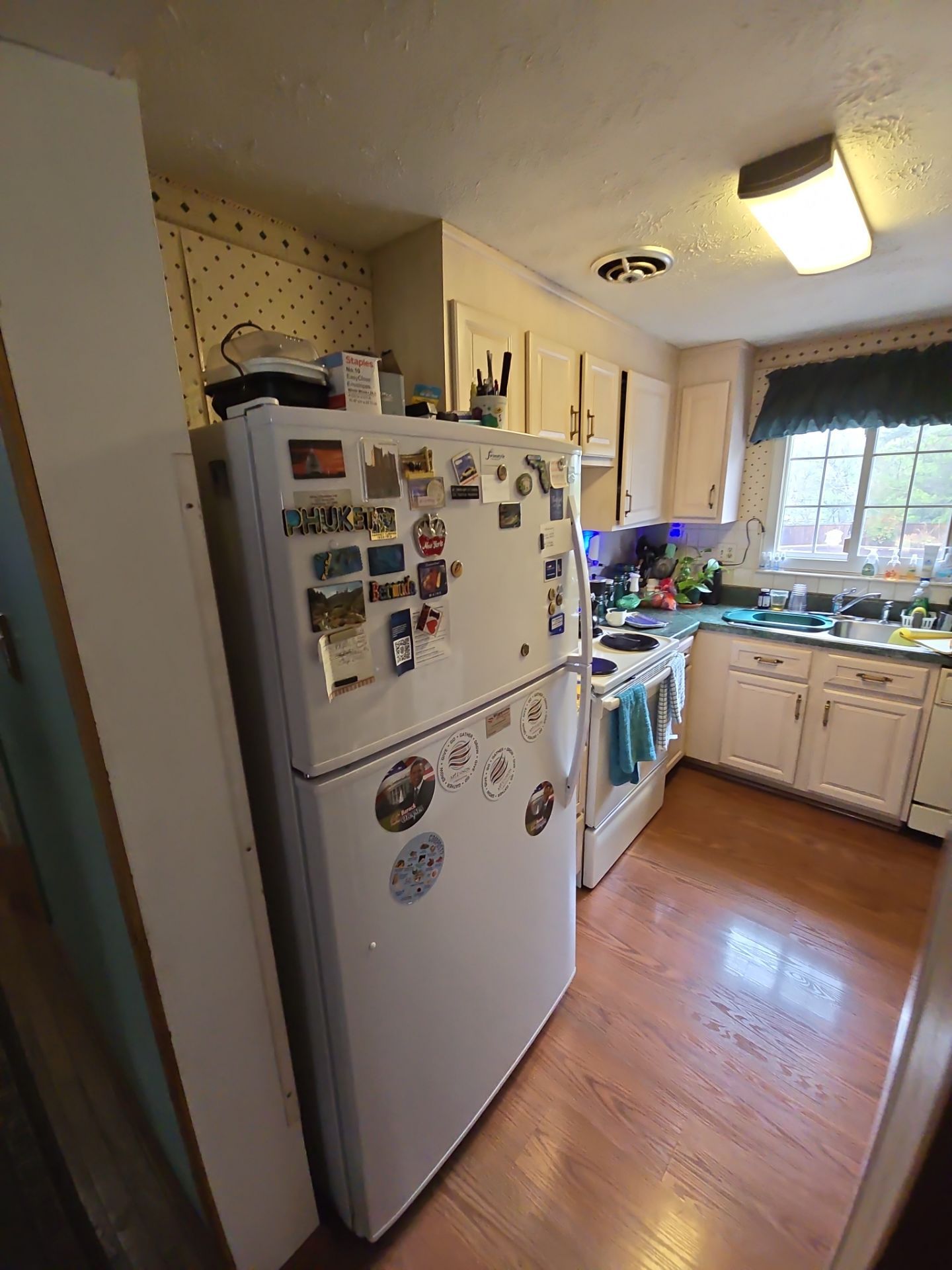 A kitchen with a refrigerator , stove , and sink.