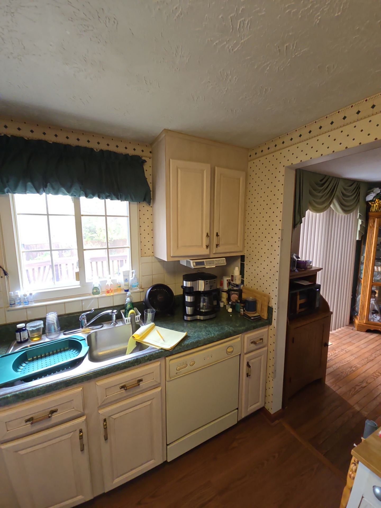 A kitchen with white cabinets and green counter tops