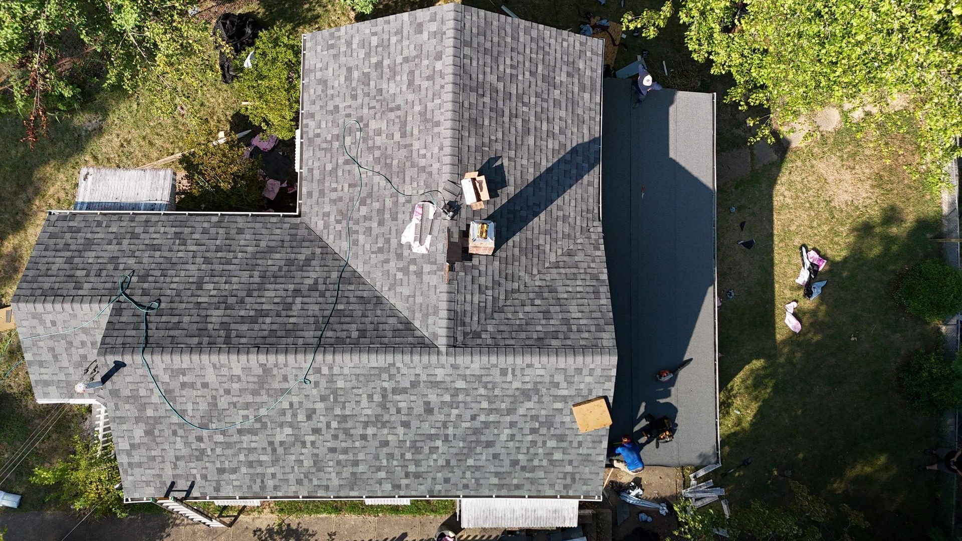 An aerial view of a house with a roof being installed.