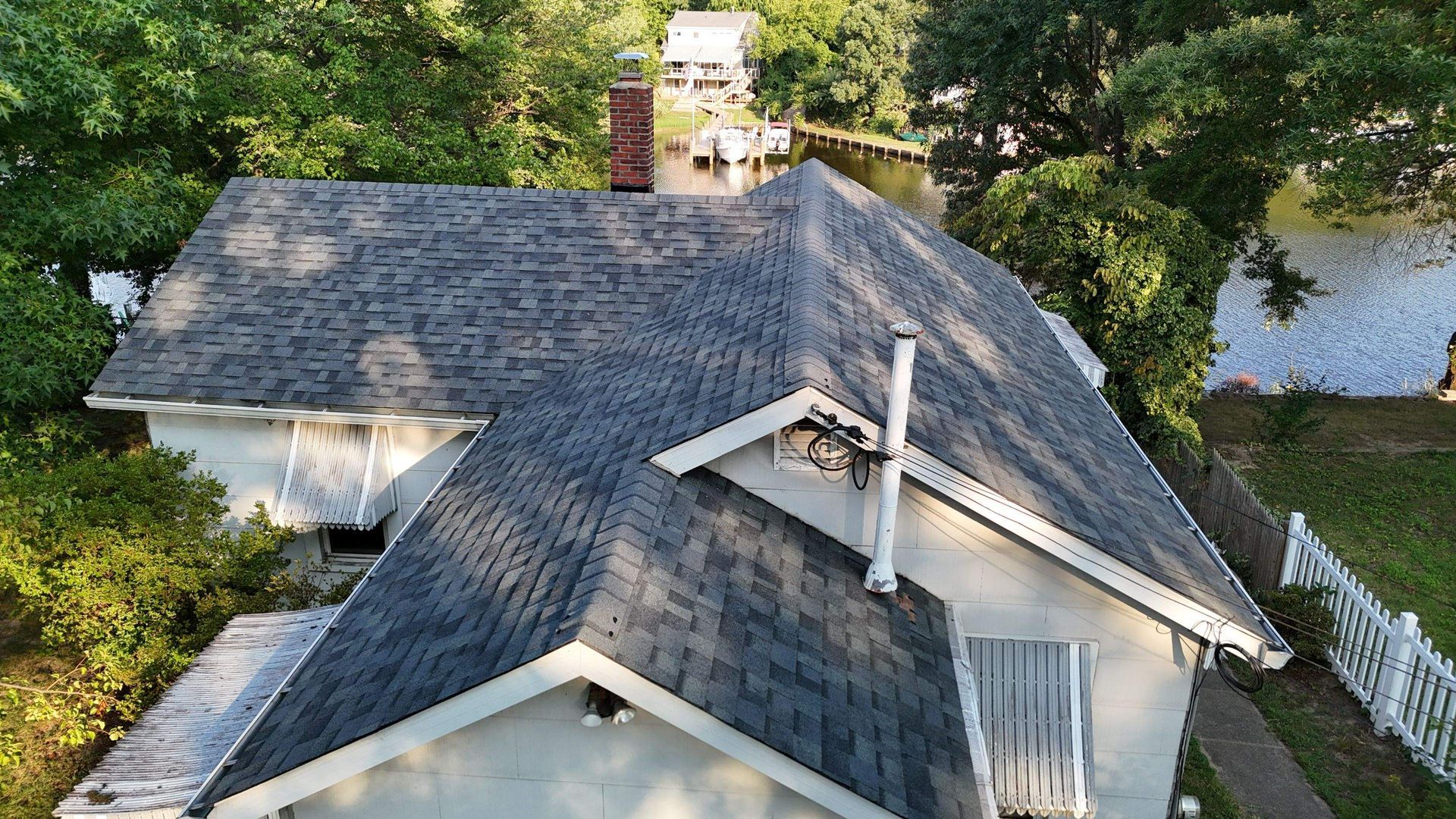 An aerial view of a house with a roof and a chimney.