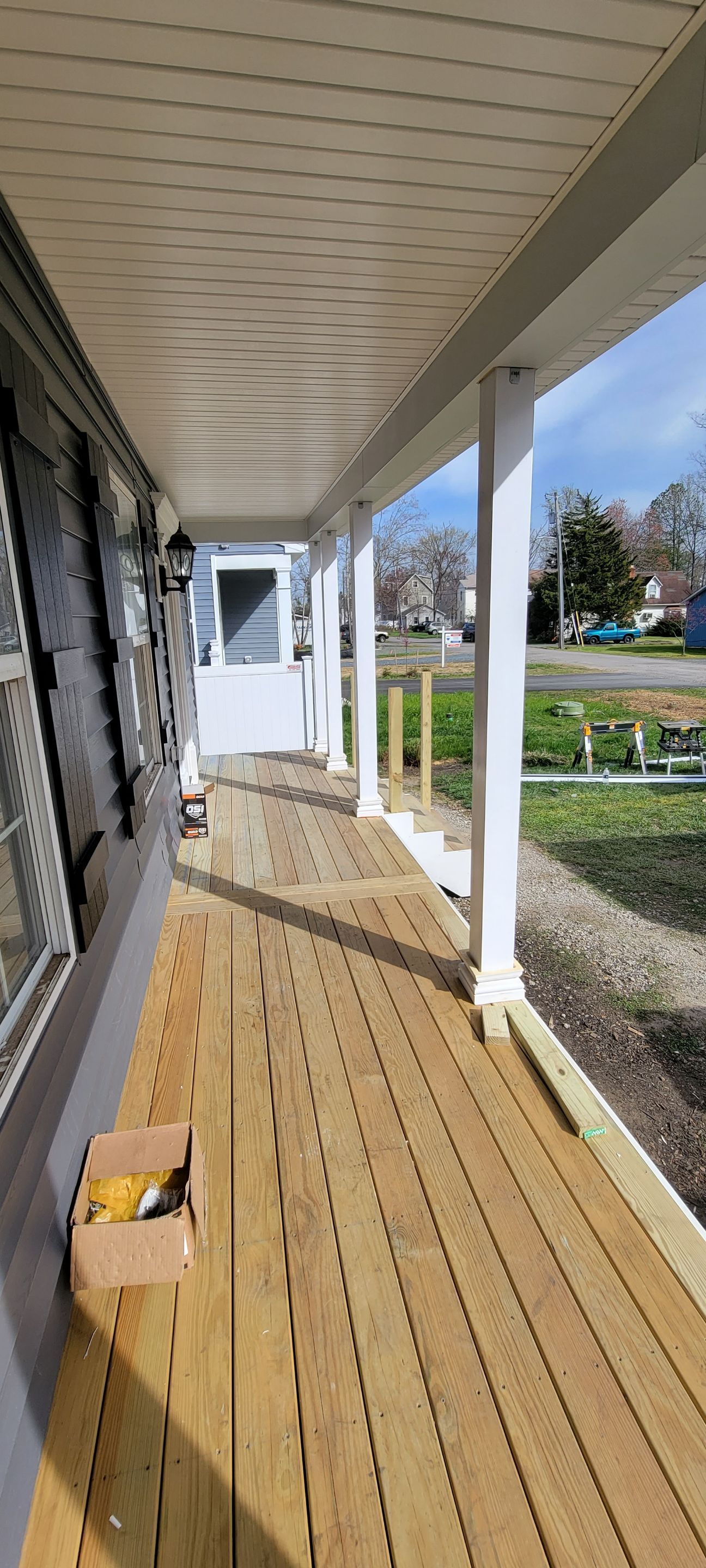 A wooden porch is being built on the side of a house.