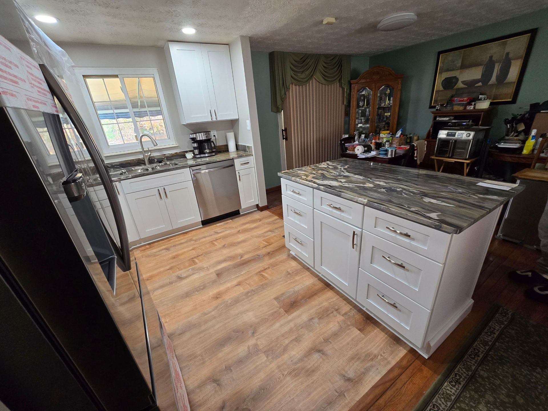 A kitchen with a large island in the middle of the room.