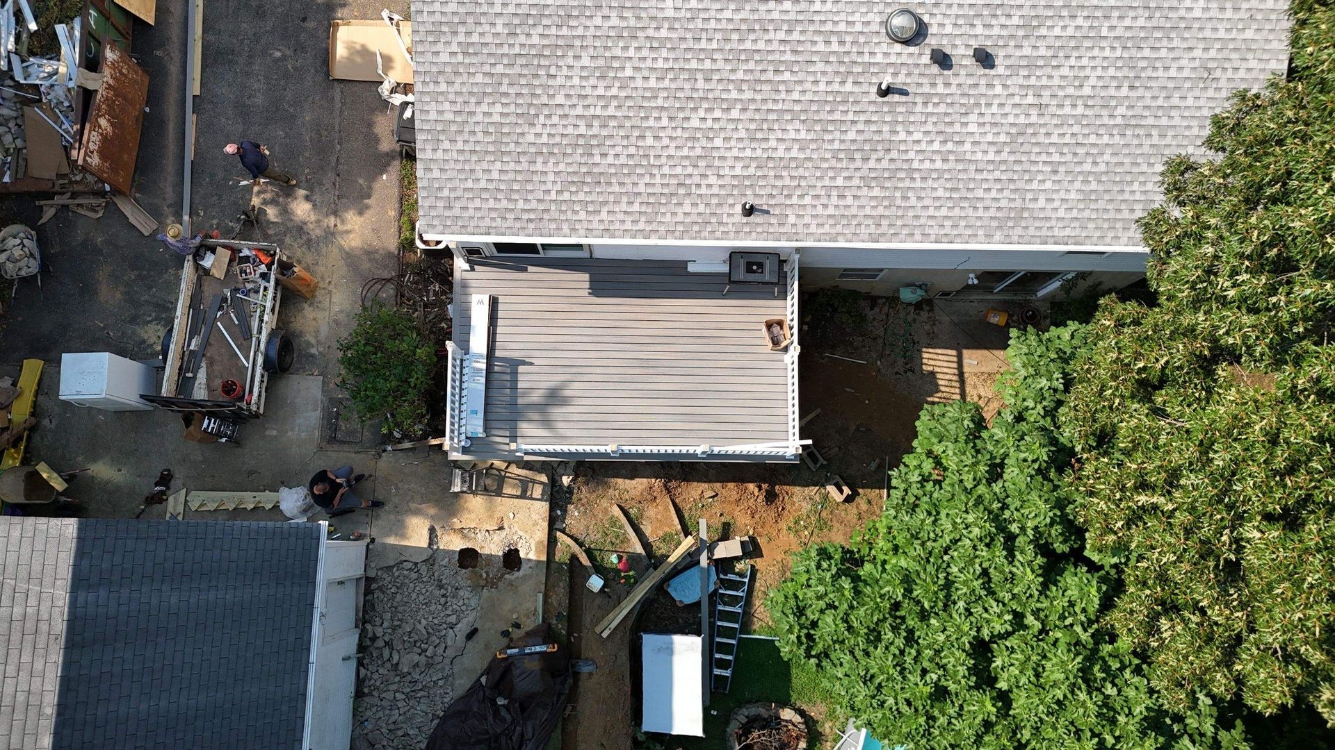 An aerial view of a house under construction with a deck.