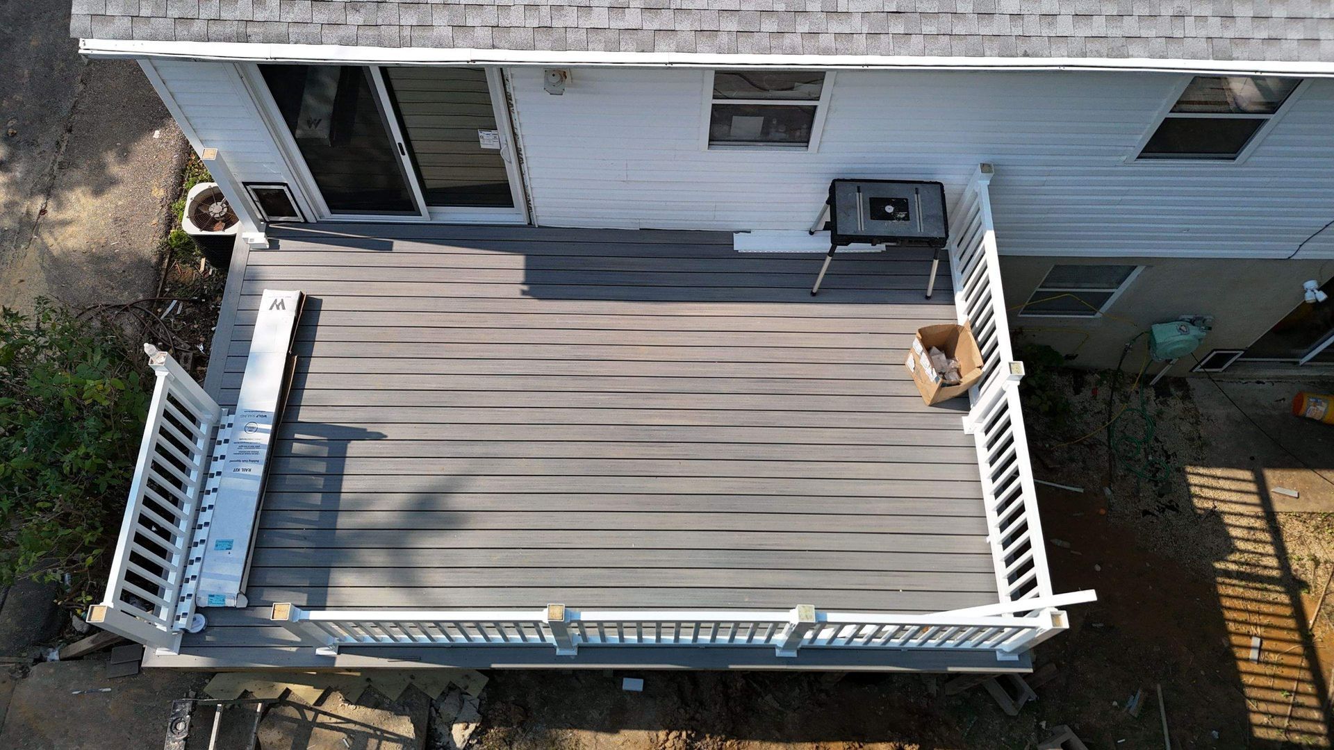 An aerial view of a deck in front of a house.