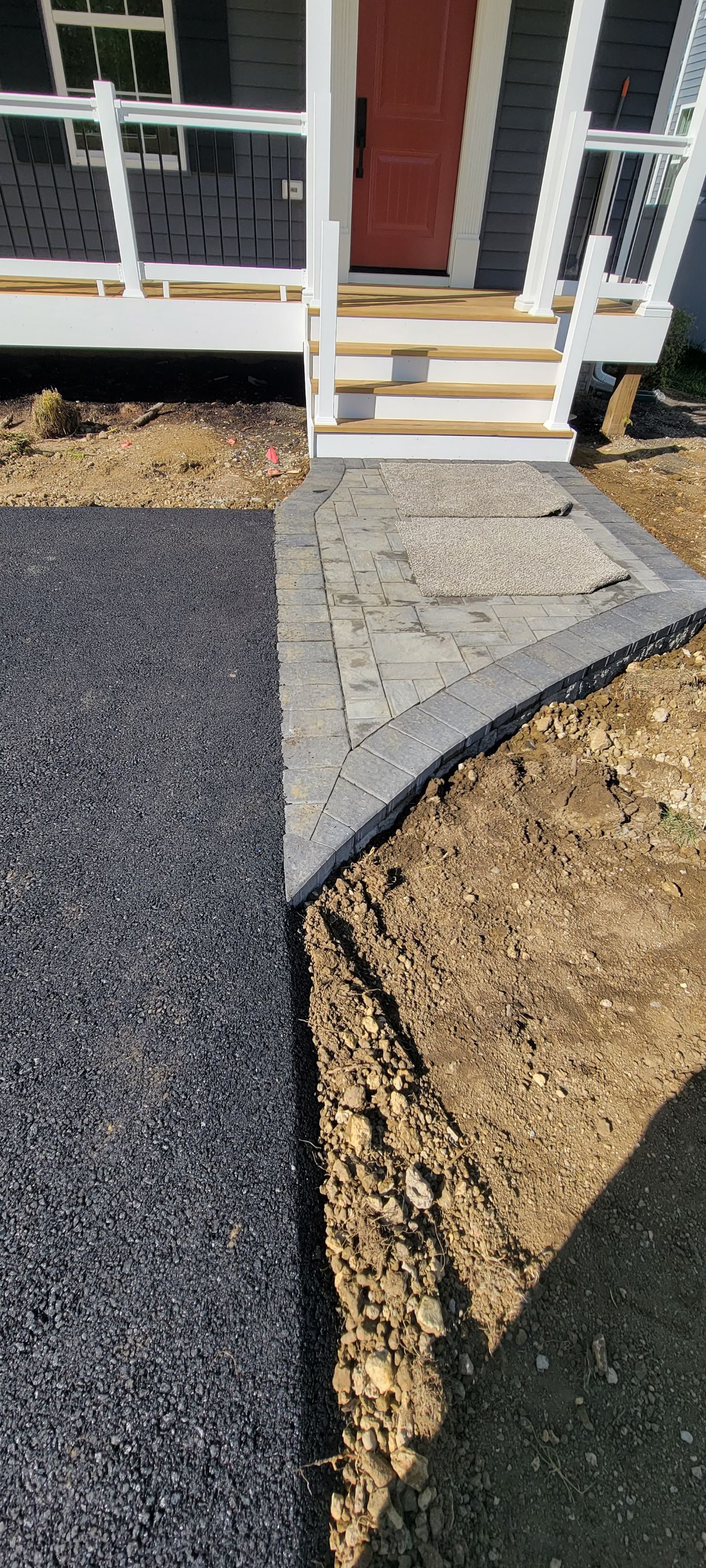 A driveway is being built in front of a house.