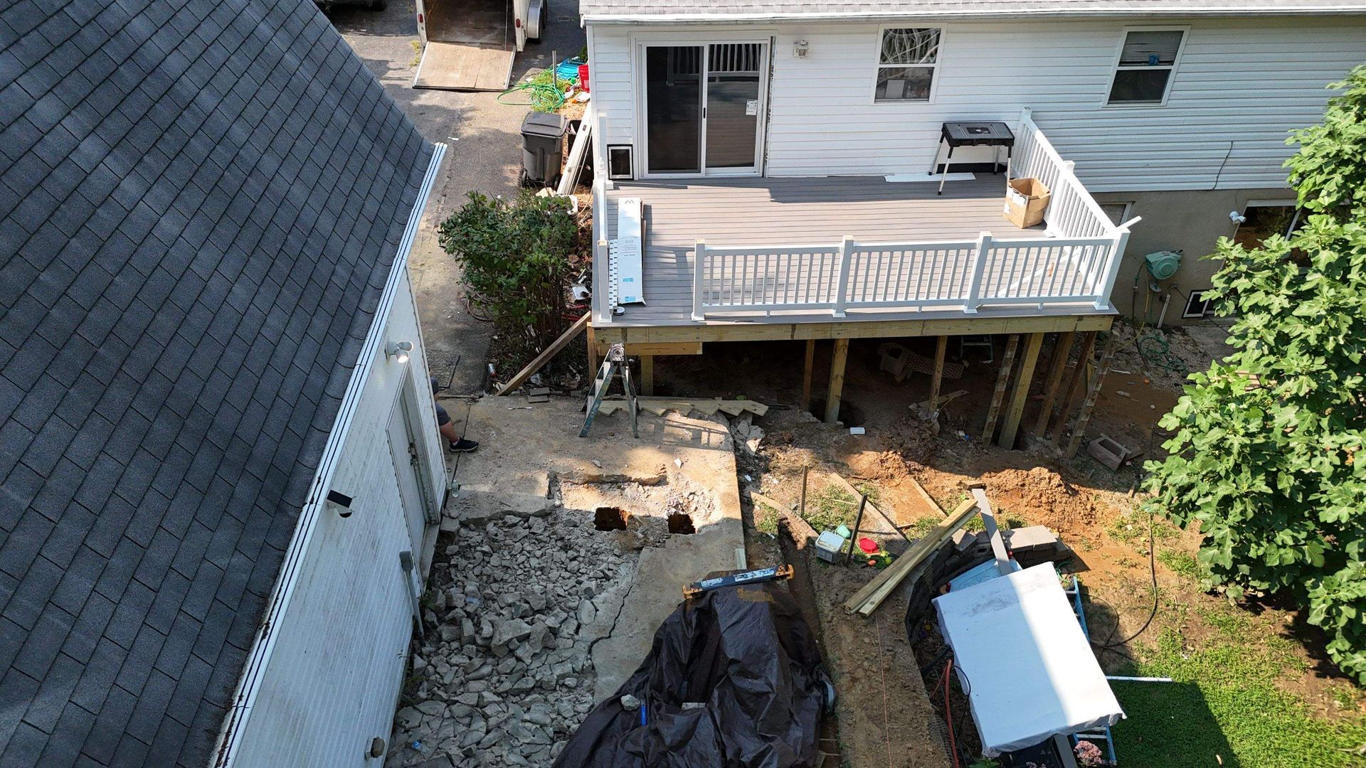An aerial view of a house with a deck in the backyard.