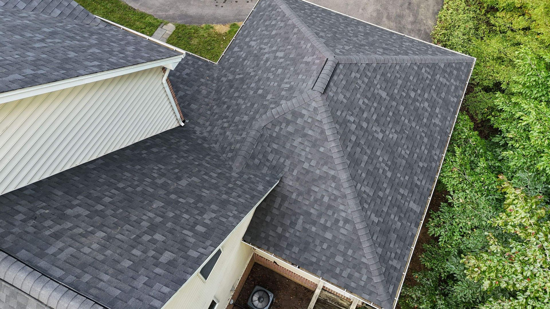 An aerial view of a house with a black roof.
