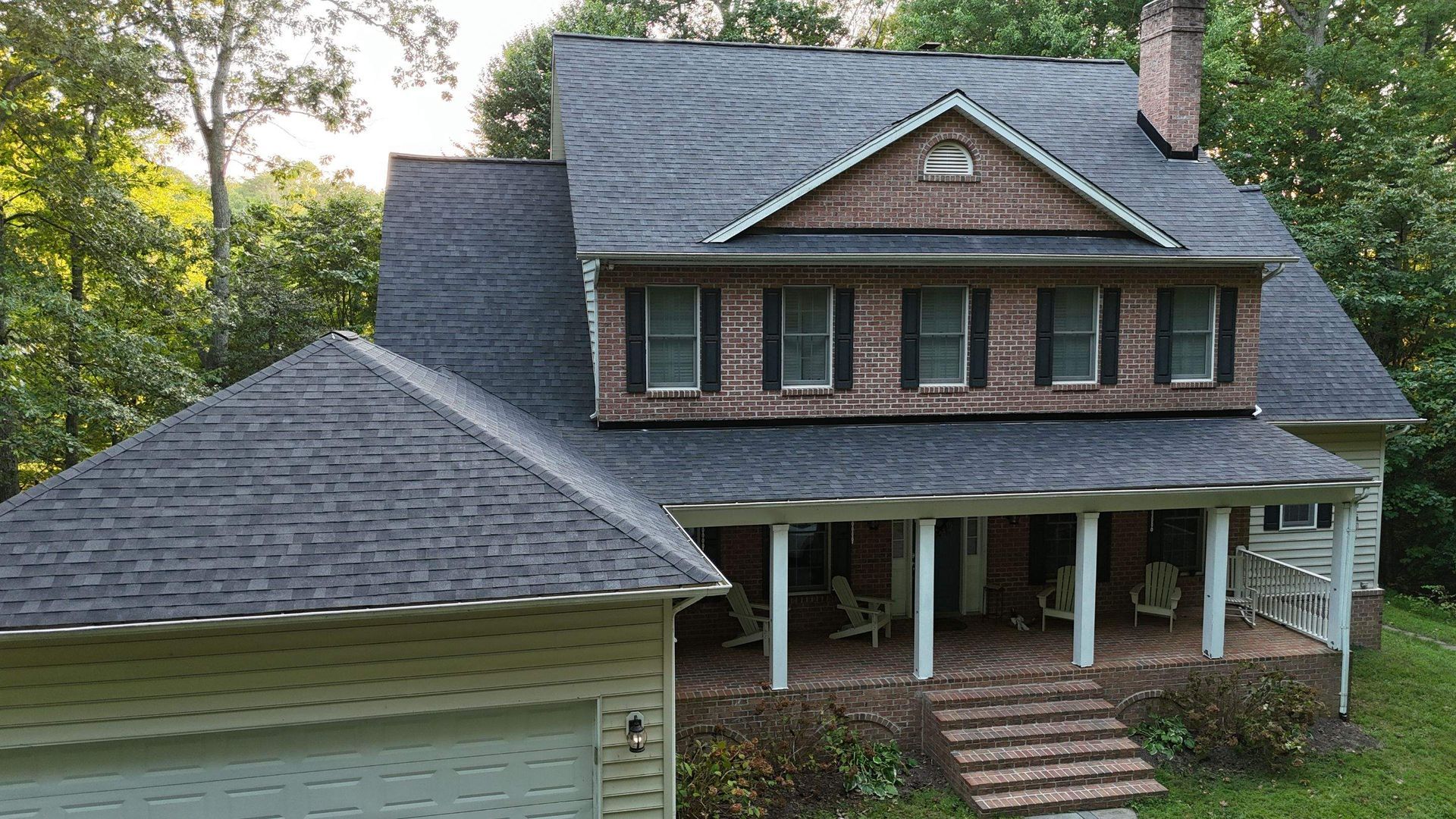 A large brick house with a porch and a garage