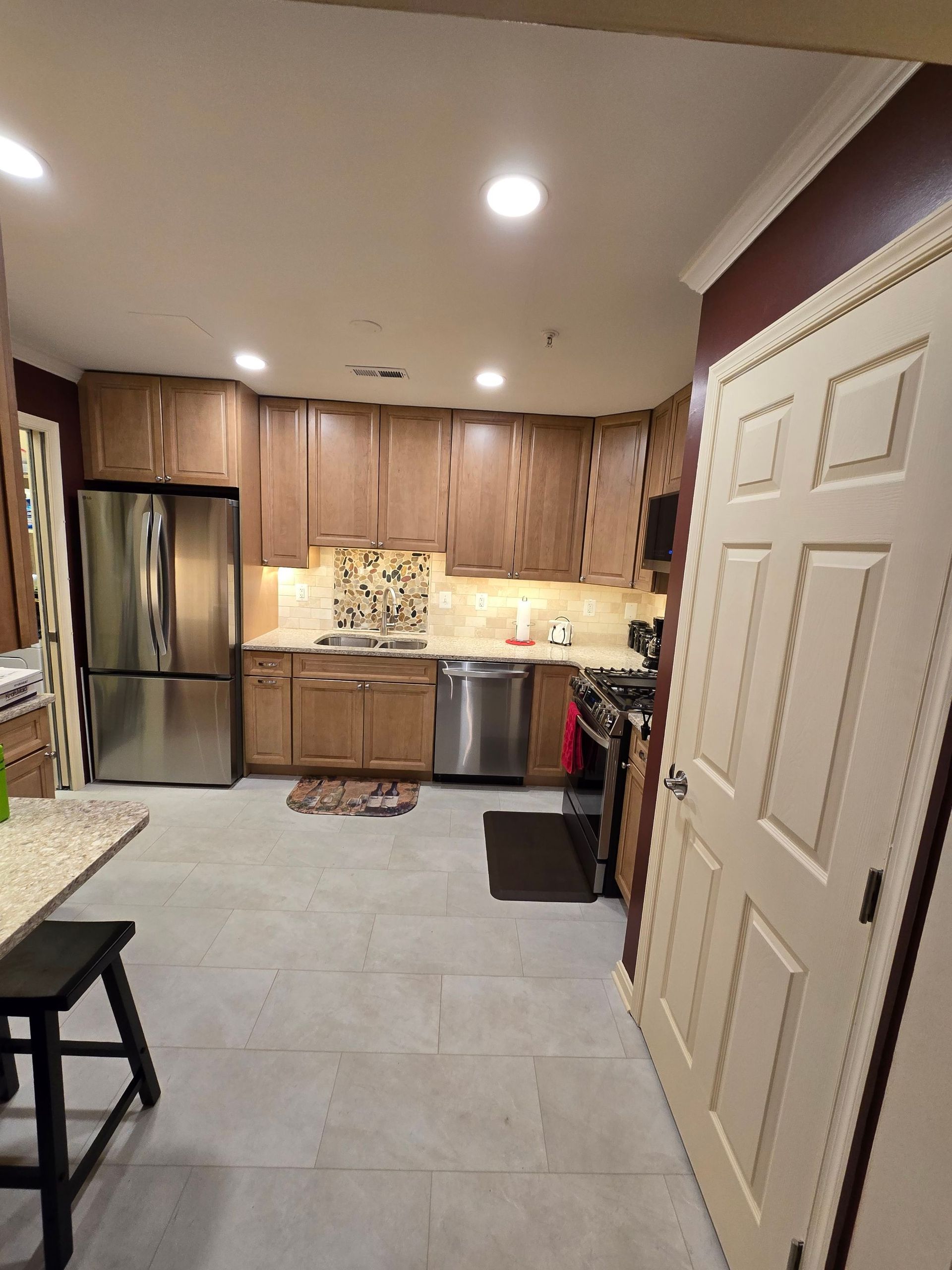 A kitchen with stainless steel appliances and wooden cabinets