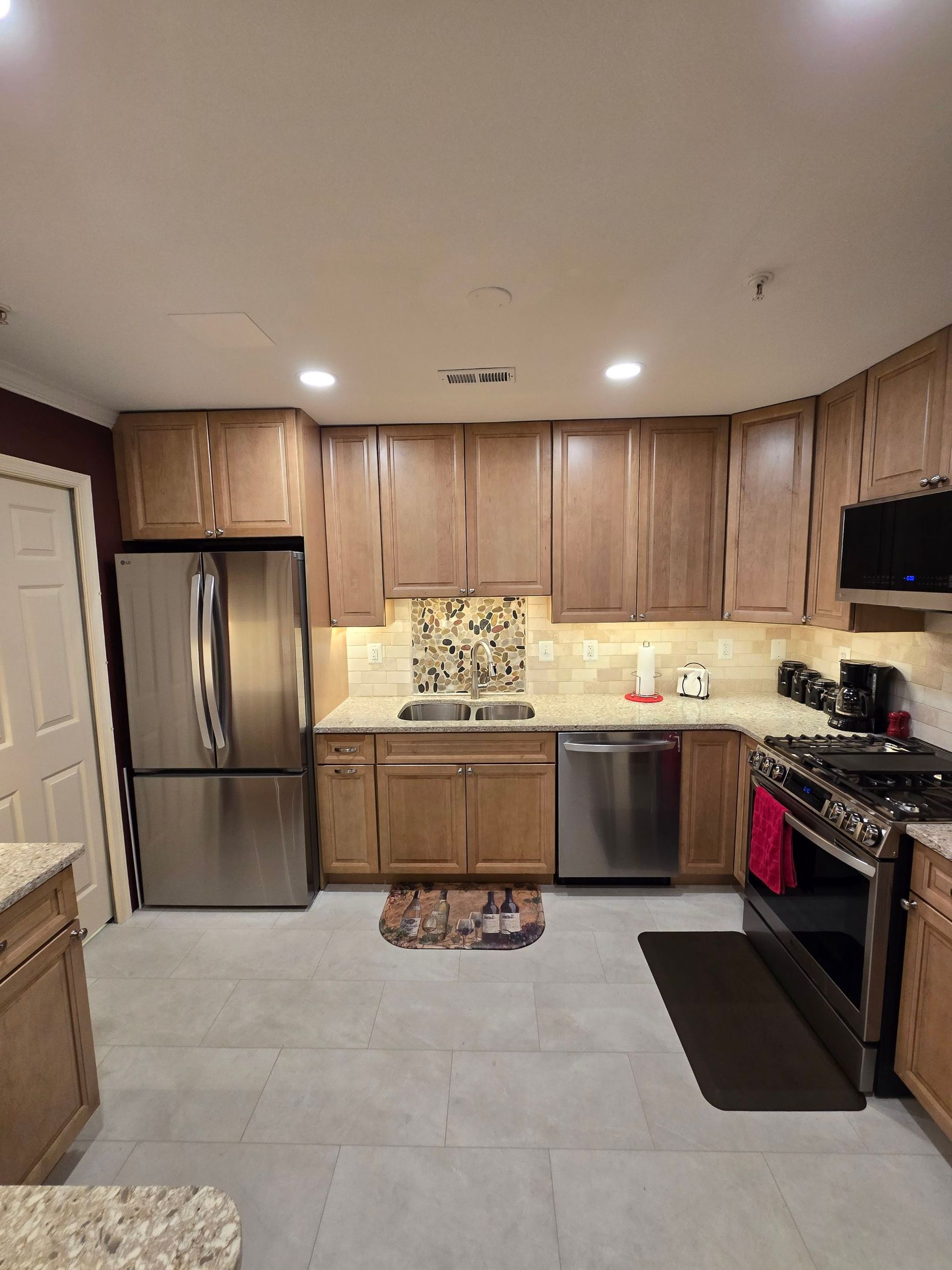 A kitchen with stainless steel appliances and wooden cabinets