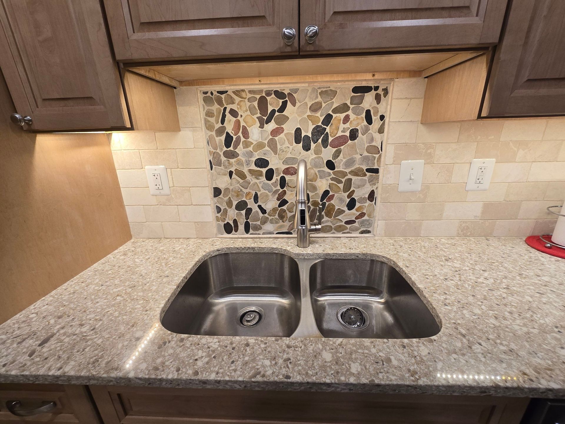 A kitchen with two sinks and a granite counter top