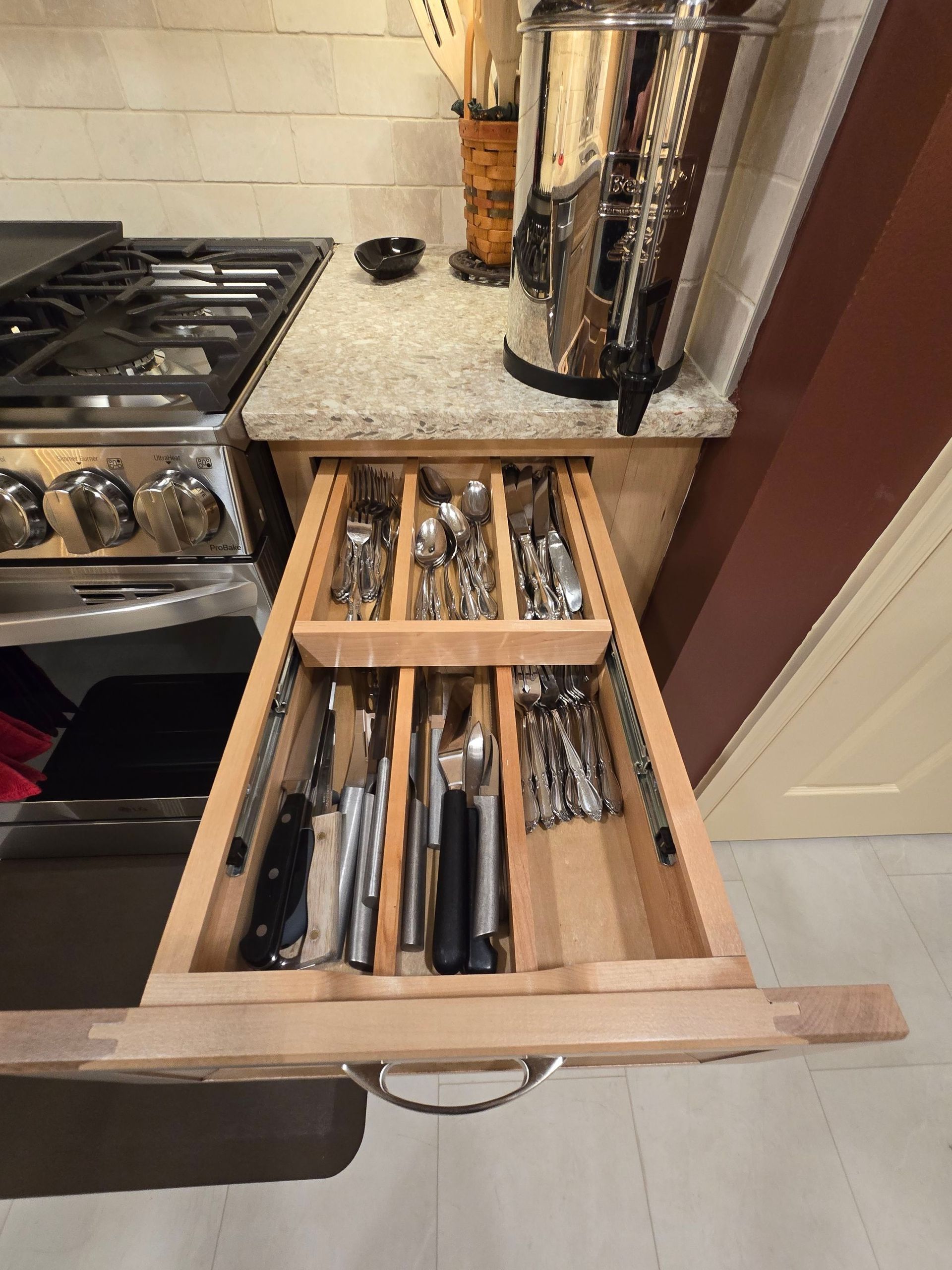 A kitchen drawer filled with utensils and knives
