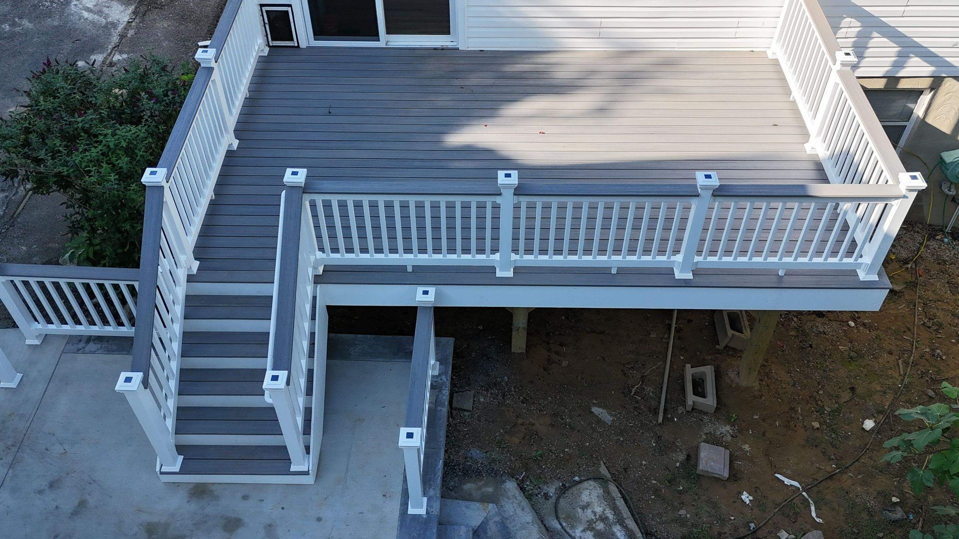 An aerial view of a deck with stairs and a white railing.