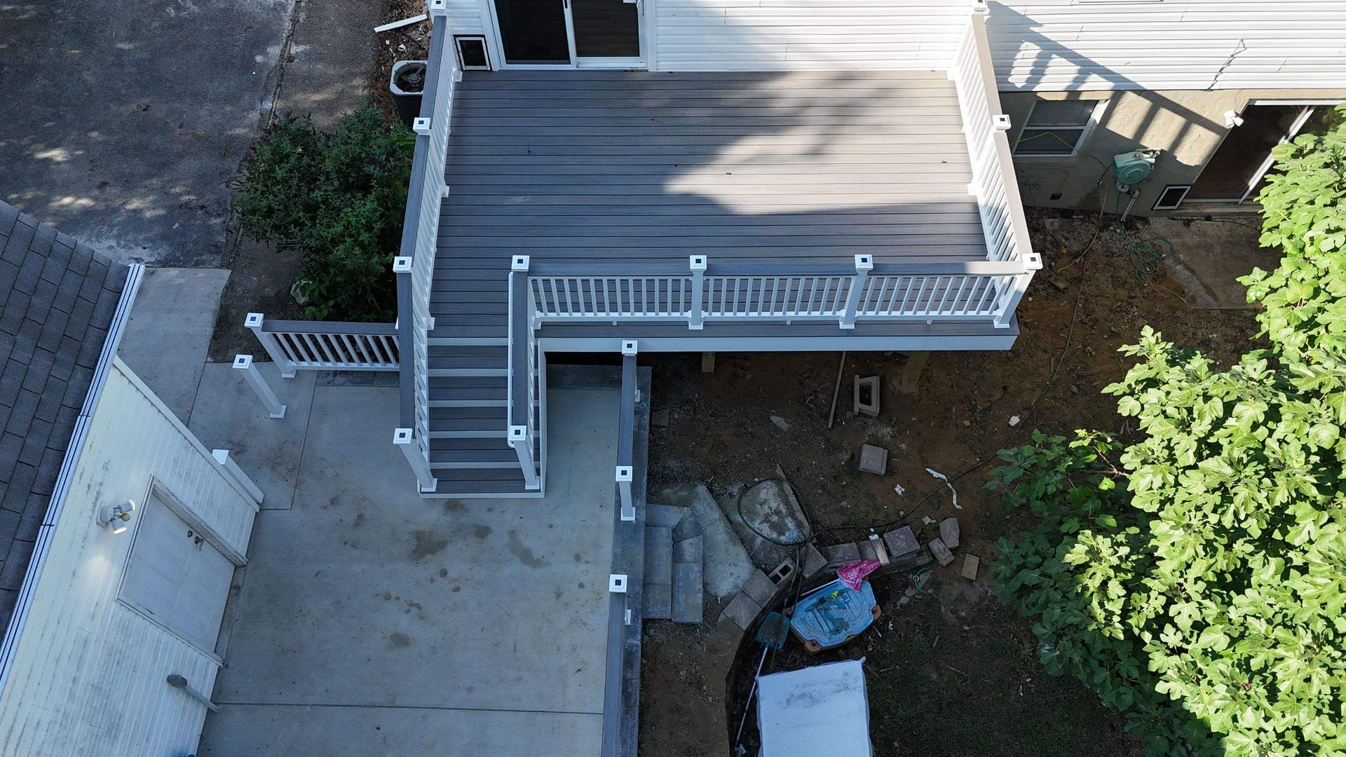 An aerial view of a house with a large deck and stairs.